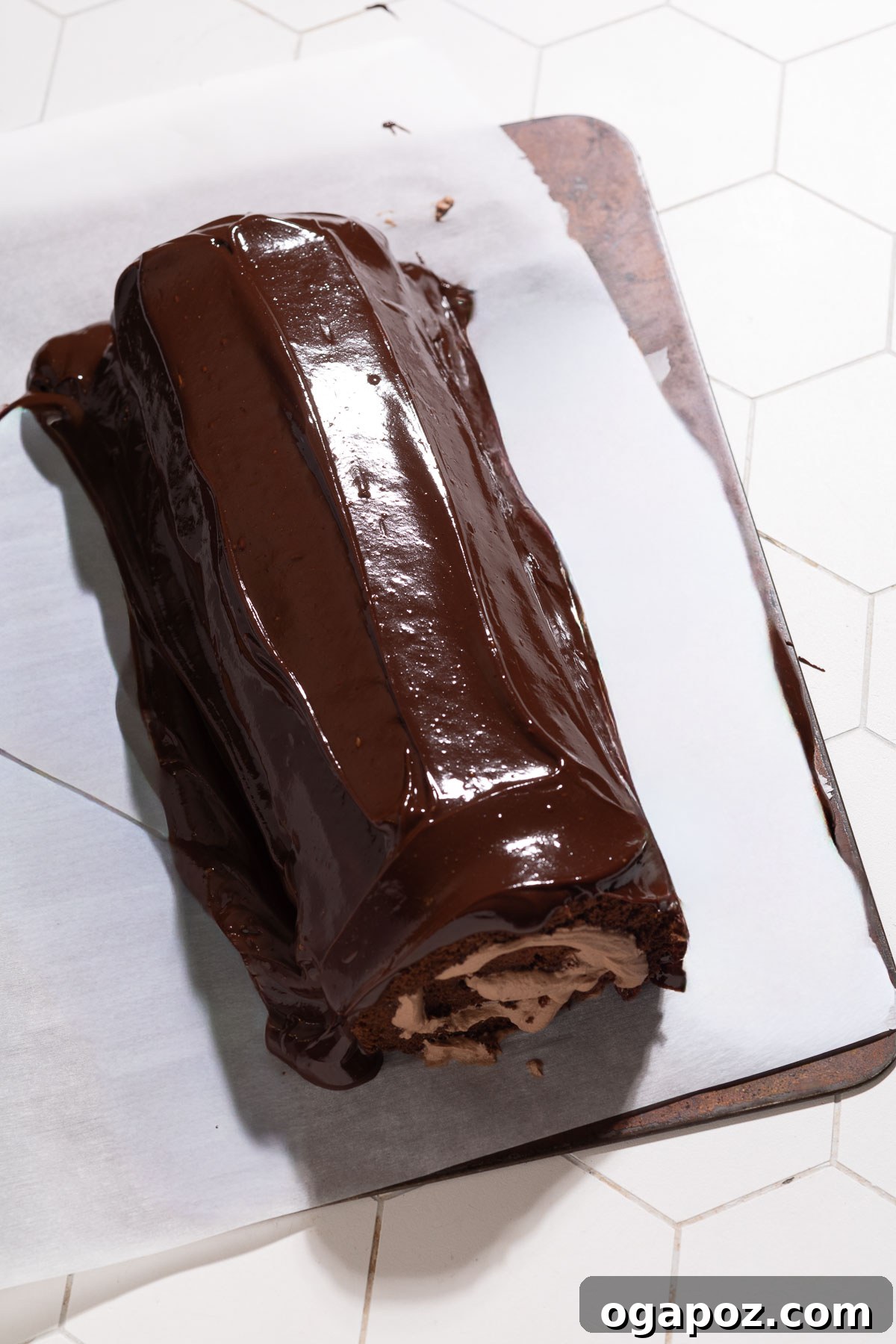 Perfect Christmas Yule Log Cake 10 Decorating the Yule Log with chocolate ganache and a fork to create bark texture.