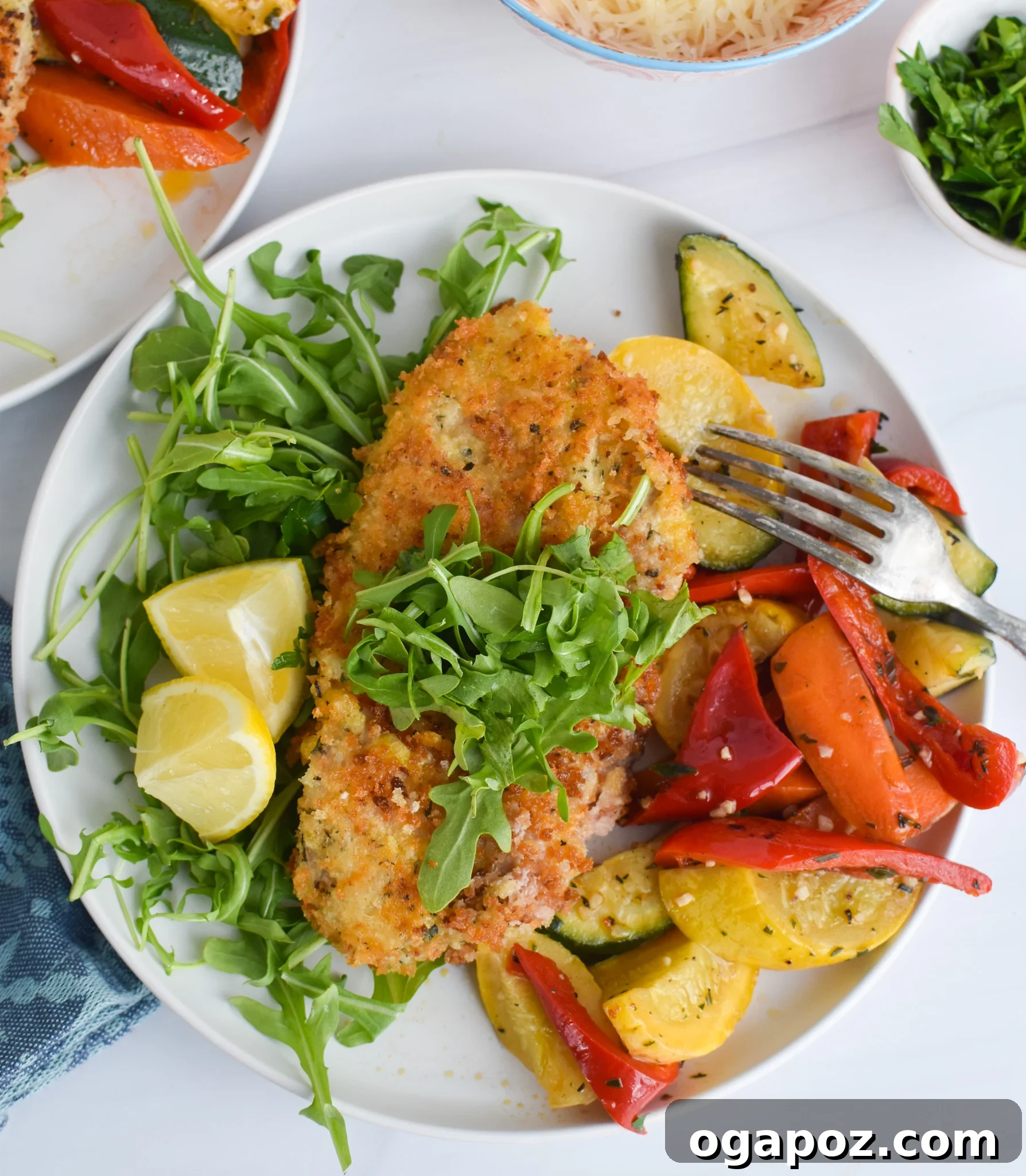 Crispy Veal Milanese served alongside fresh vegetables.