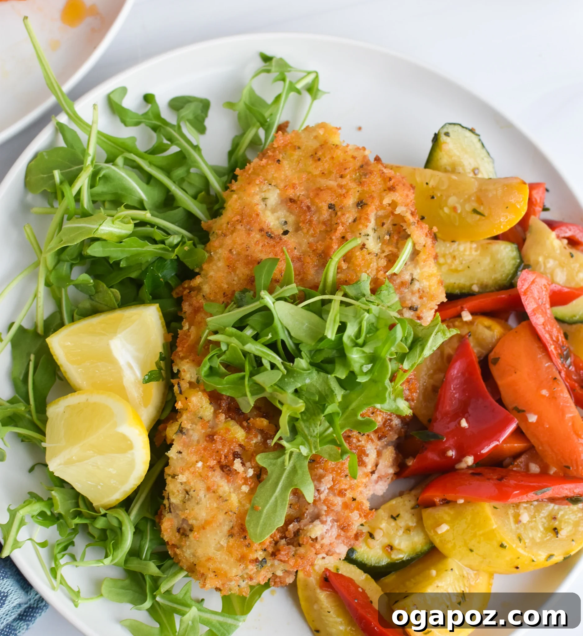 A fork taking a bite of crispy Veal Milanese.