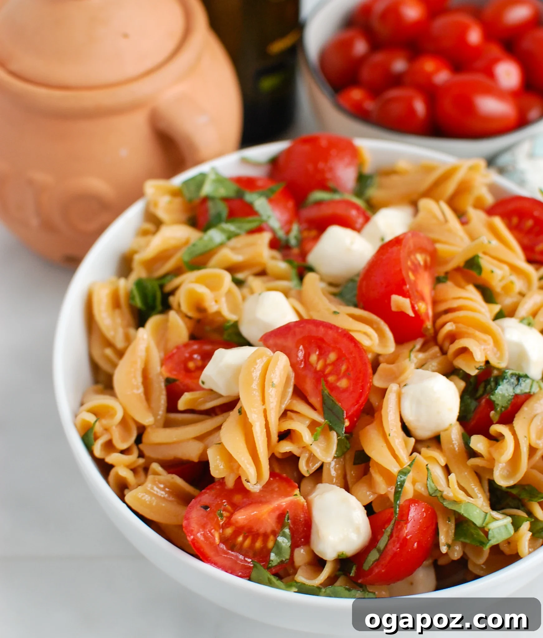 Vibrant Caprese Pasta 2 A vibrant bowl of Caprese Pasta, featuring fresh mozzarella, cherry tomatoes, and basil leaves, tossed in a light dressing.
