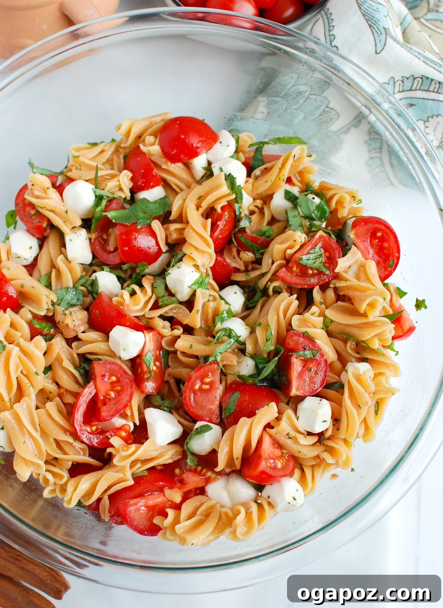 Vibrant Caprese Pasta 4 Caprese Pasta ready to be served in a glass bowl, garnished with fresh basil.