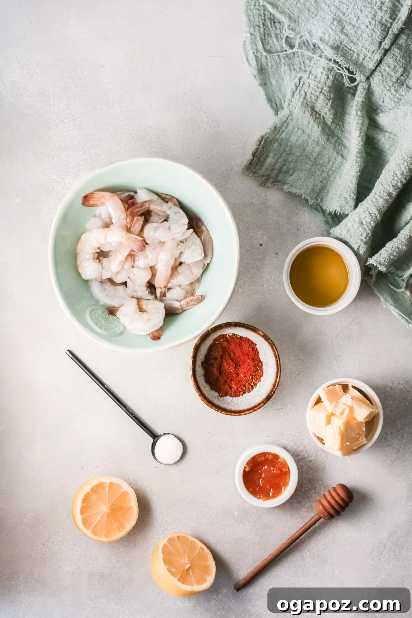 Spicy Southern Shrimp in Minutes 3 Key ingredients laid out for Easy Cajun Shrimp Recipe: raw shrimp, seasoning blend, a jar of honey, butter, and fresh lemon.