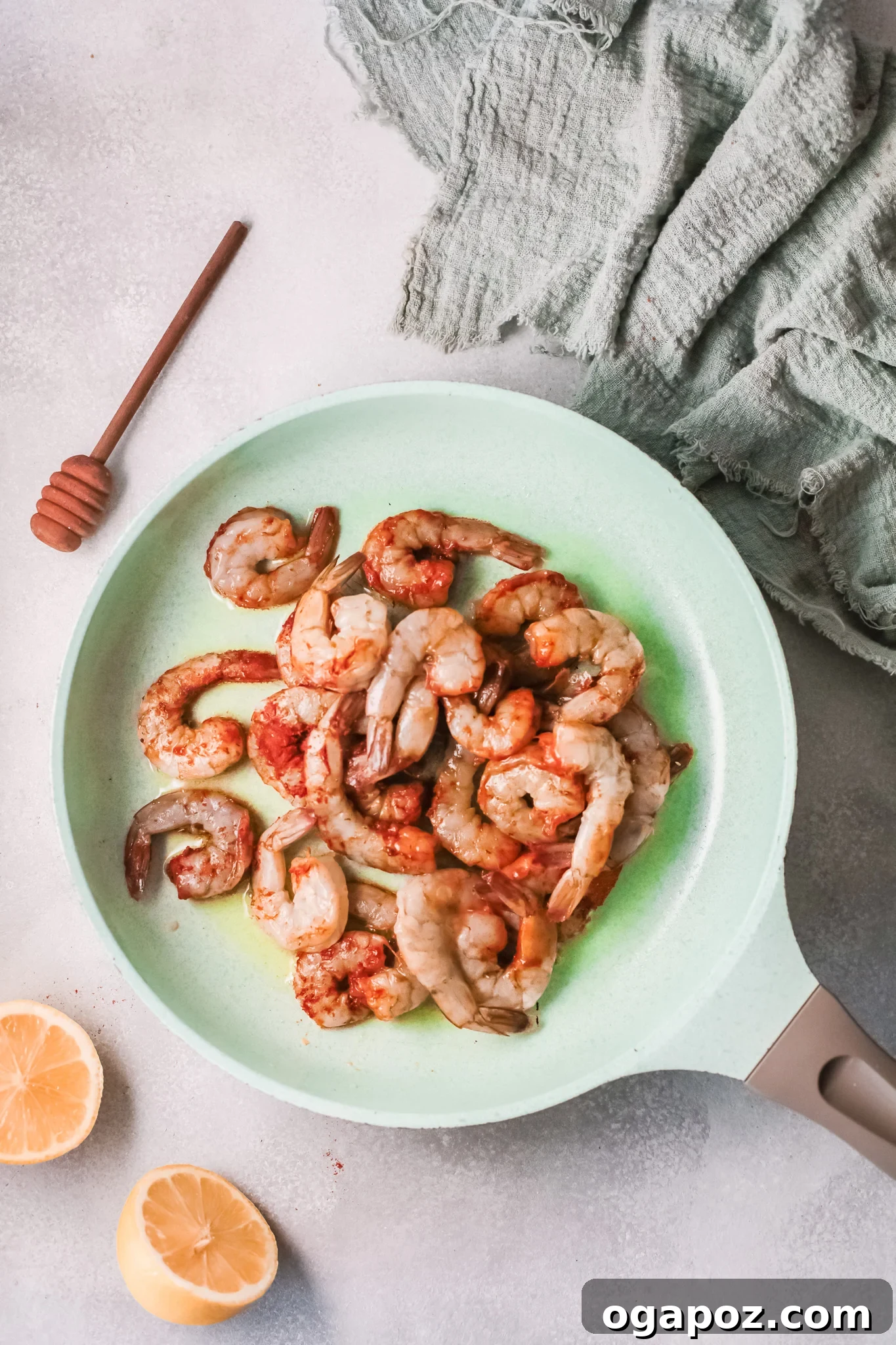 Spicy Southern Shrimp in Minutes 6 Shrimp searing in a hot skillet with olive oil, developing a beautiful pink hue and slight char.