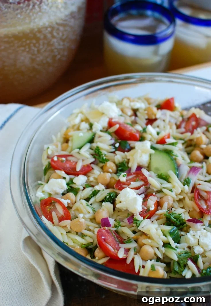 Refreshing Summer Orzo Pasta Salad with chickpeas, feta, and fresh vegetables.