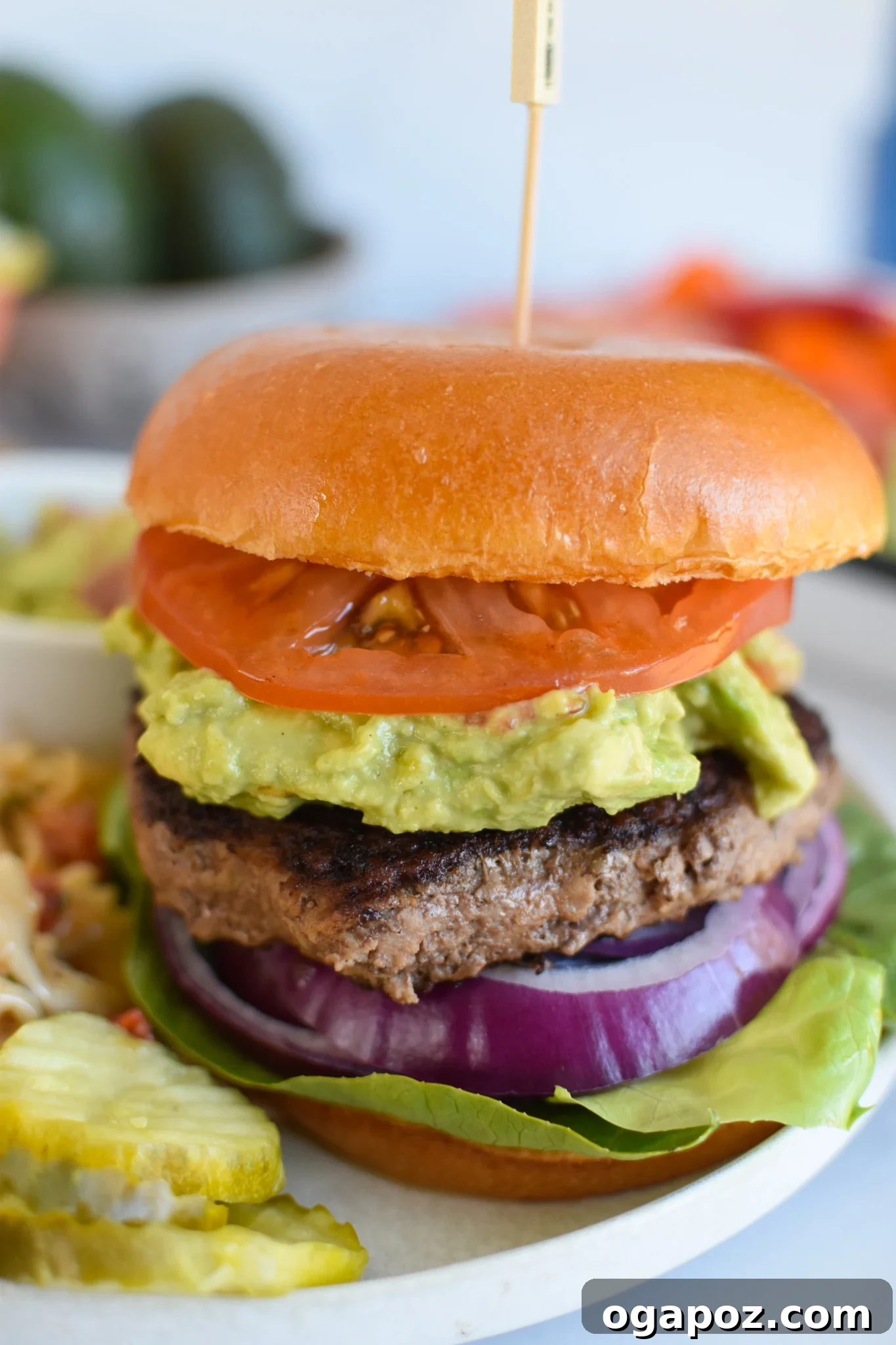 Creamy Avocado Burger 4 Assembled Easy Avocado Burger with bun and a generous topping of guacamole.