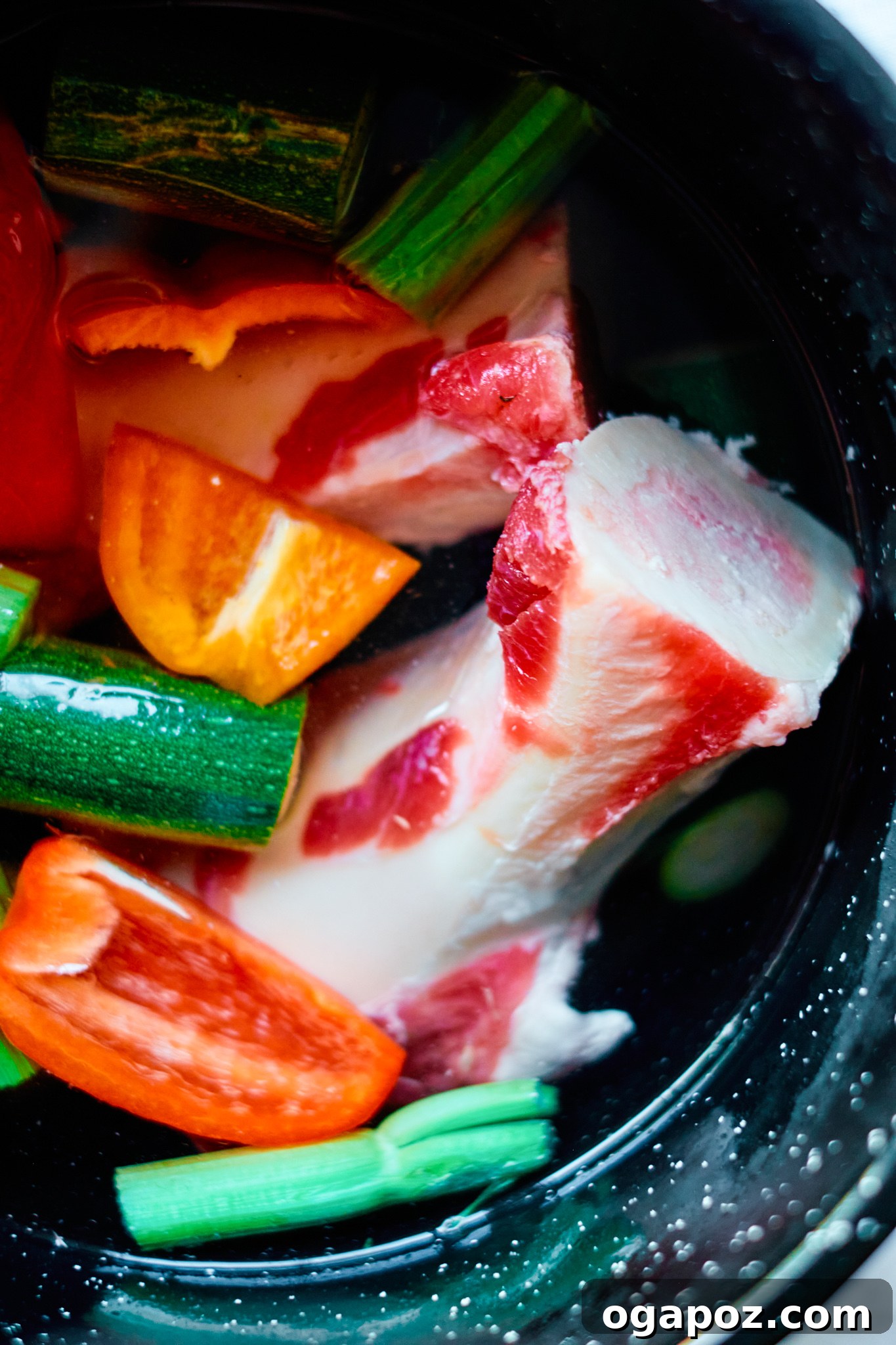 Nourishing Beef Bone Broth Made Simple 3 Easy Beef Bone Broth bones and vegetables in a pot.