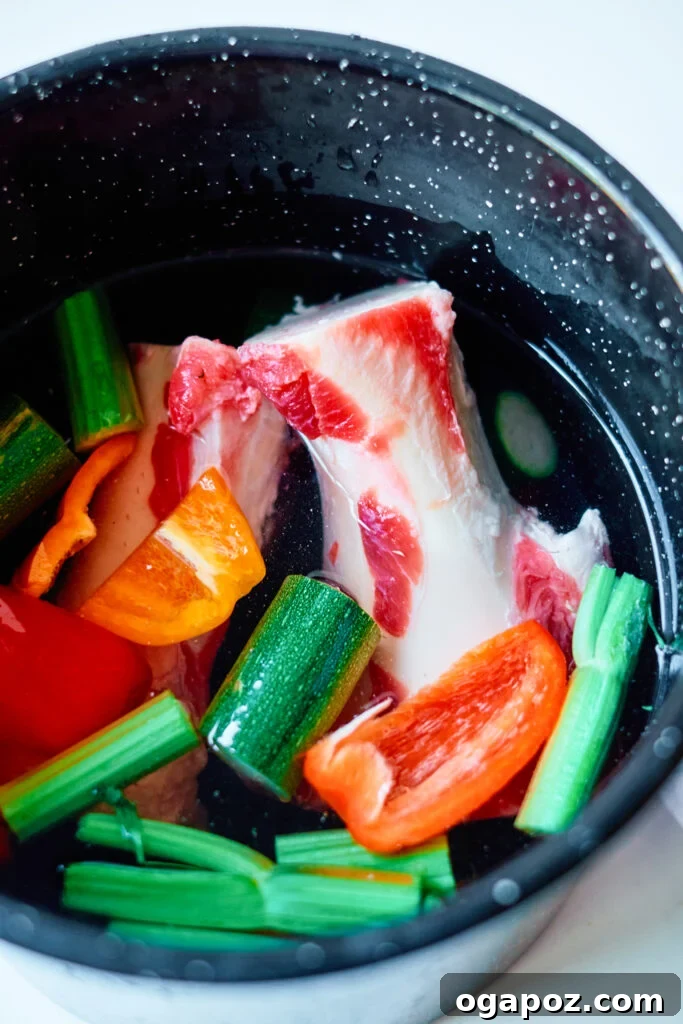 Nourishing Beef Bone Broth Made Simple 5 Easy Beef Bone Broth Recipe simmering in a large pot on the stovetop.