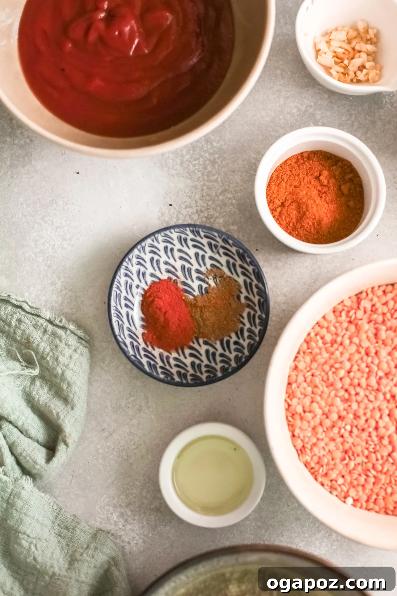 Spiced Red Lentil Curry 3 A selection of fresh ingredients laid out, including red lentils, ginger, garlic, onions, tomato sauce, and various spices, ready for making Red Lentil Curry.