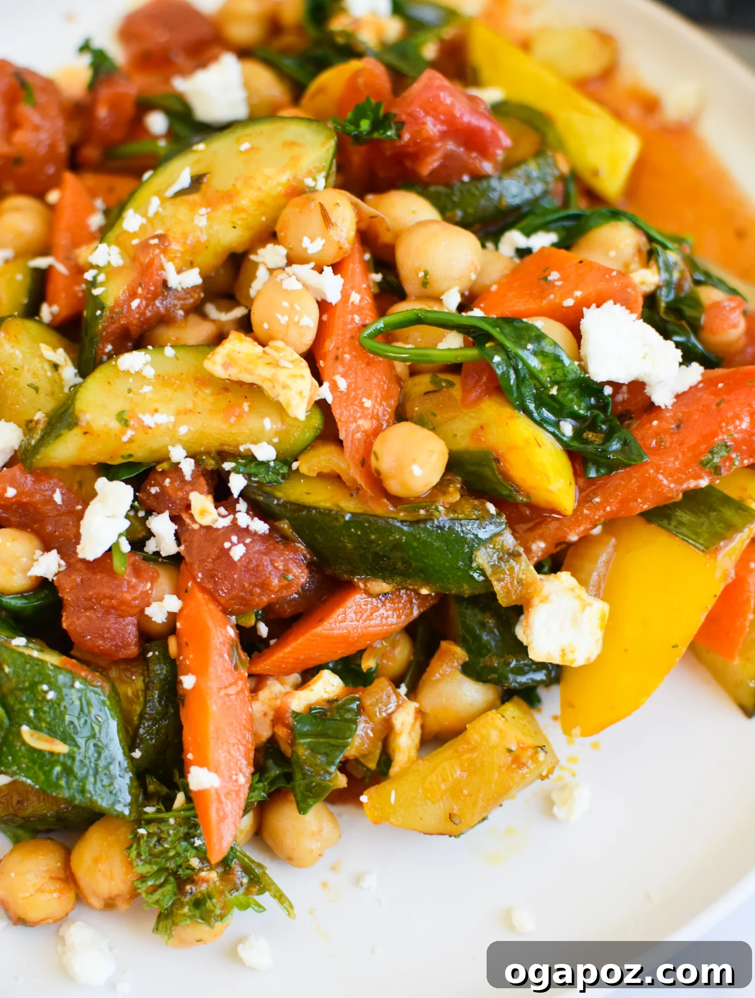 Vibrant Mediterranean Chickpea Skillet 2 Vibrant Mediterranean Chickpea Skillet with crumbled feta cheese and fresh parsley garnish, served in a rustic bowl.