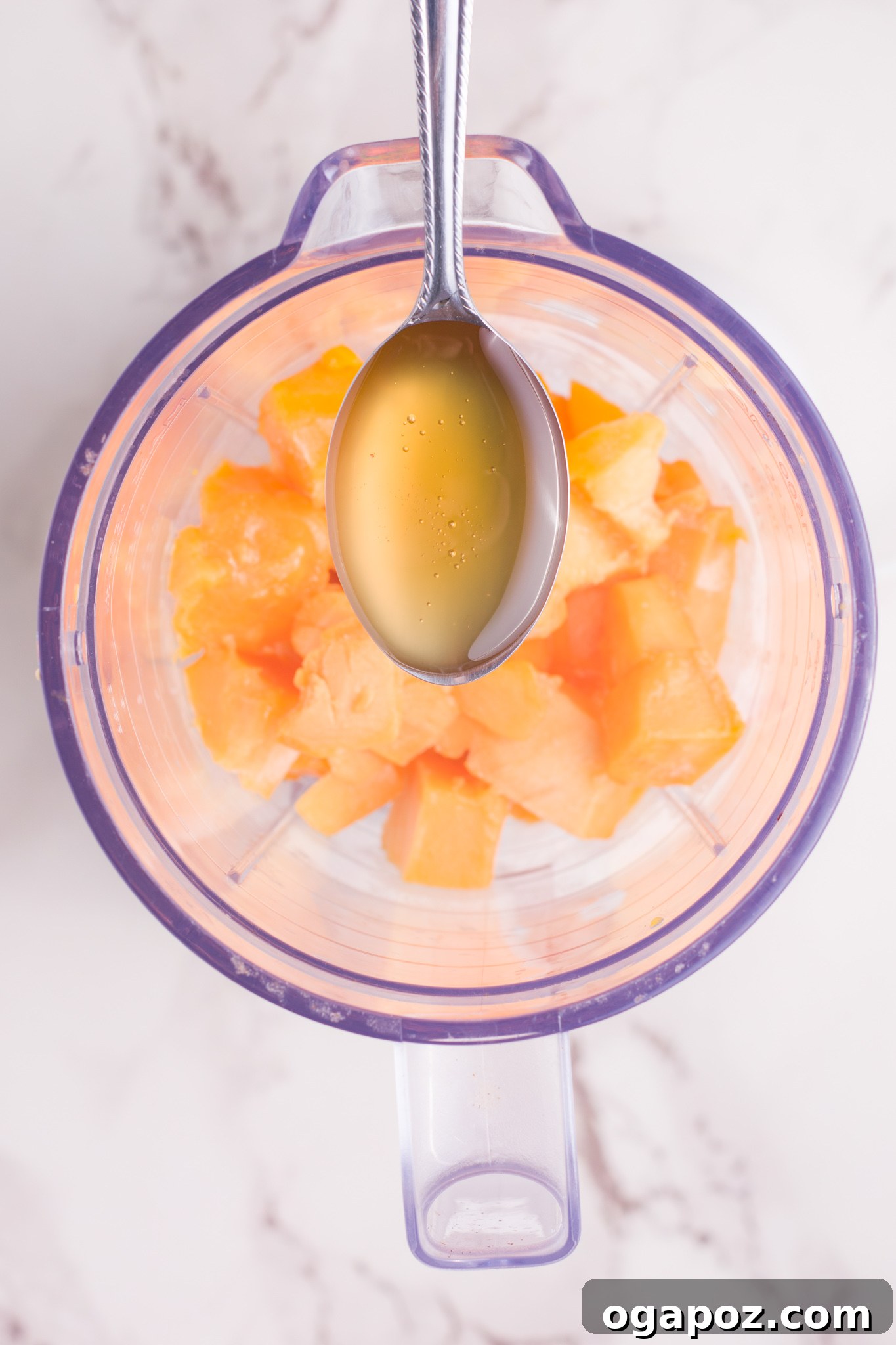 Velvety Mango Lassi 5 Mango Lassi mixture swirling smoothly inside a blender, halfway through the blending process.