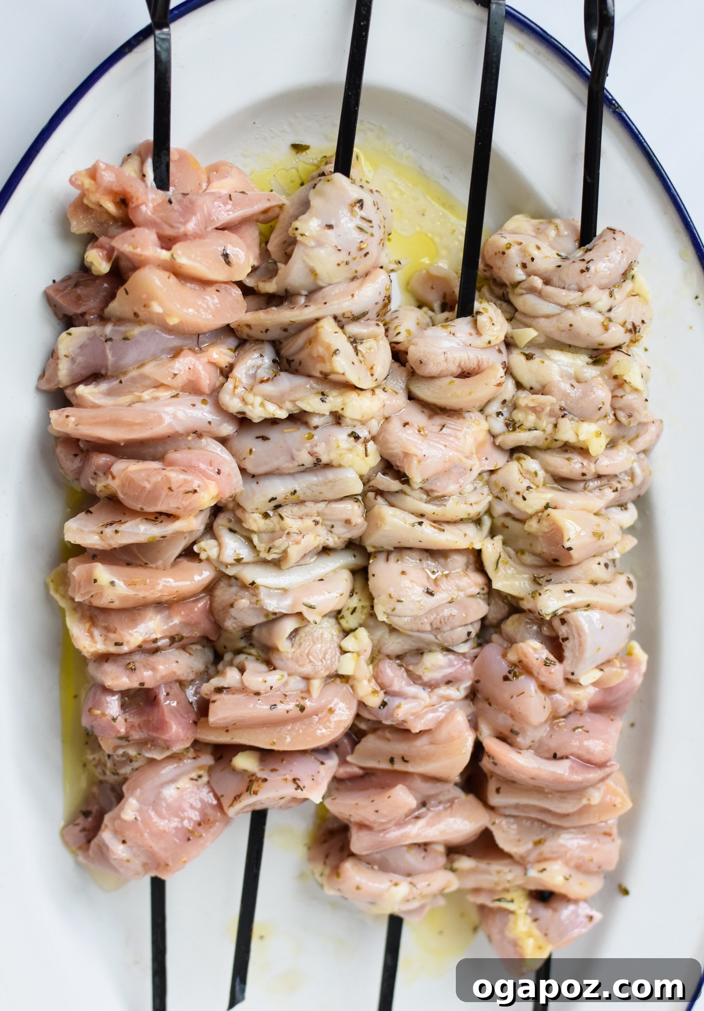 Classic Greek Chicken Souvlaki 7 Raw chicken pieces threaded onto skewers, ready for grilling, for the Chicken Souvlaki recipe.