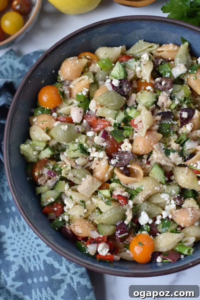 Zesty Mediterranean Tuna Pasta Salad 4 A refreshing Mediterranean Tuna Pasta Salad in a blue serving bowl, ready to be enjoyed.