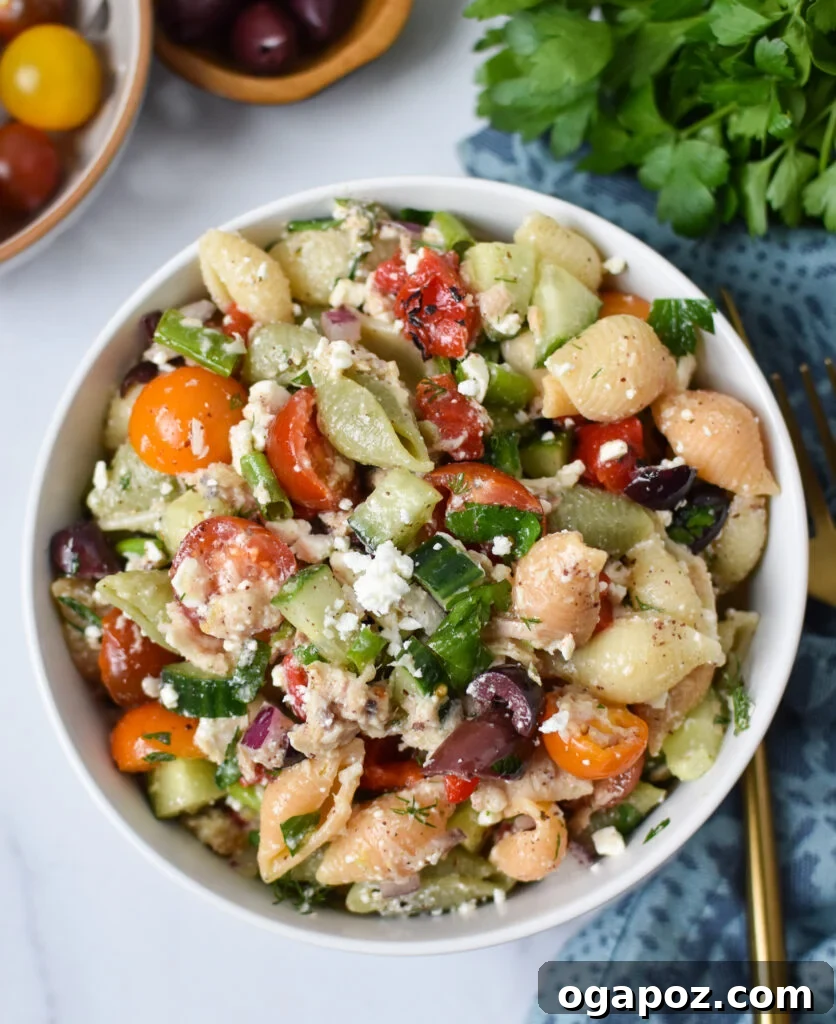 Zesty Mediterranean Tuna Pasta Salad 6 A generous serving of Mediterranean Tuna Pasta Salad in a bowl, ready to be served at a summer gathering.