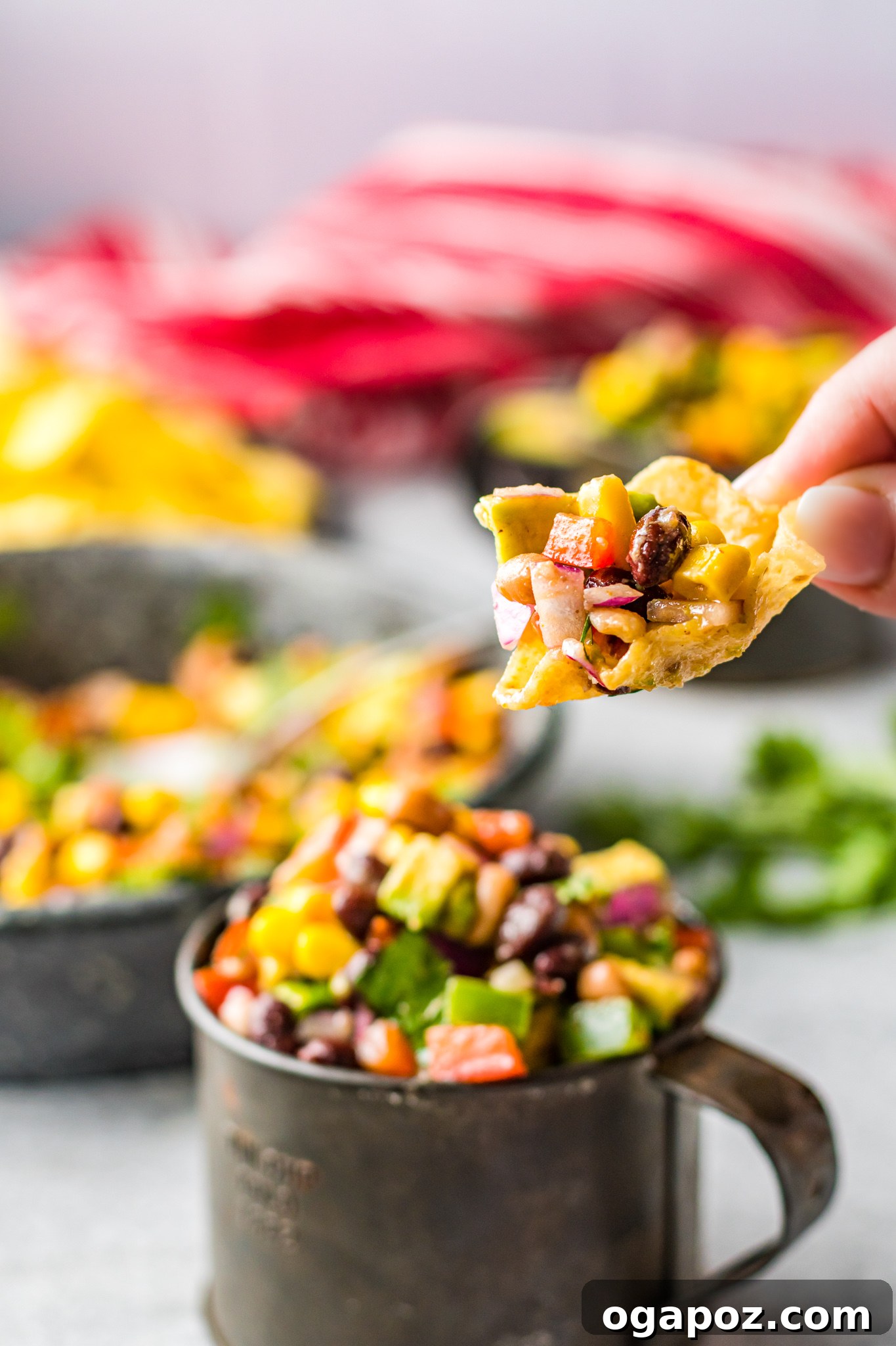 Southwestern Fiesta Dip 4 A bowl of Cowboy Caviar served with crispy tortilla chips, ready to be enjoyed as an appetizer.