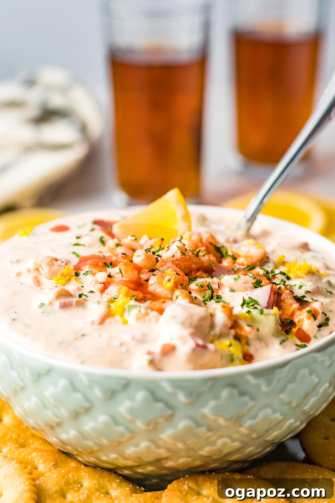 Ultimate Party Shrimp Dip 2 Shrimp Dip Recipe in light blue bowl with spoon.