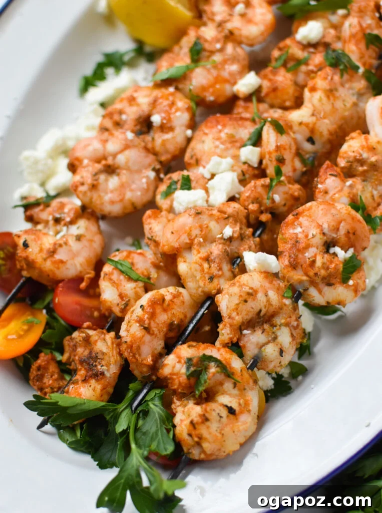 Zesty Mediterranean Grilled Shrimp Skewers 2 Platter of Mediterranean Grilled Shrimp Skewers garnished with feta cheese.