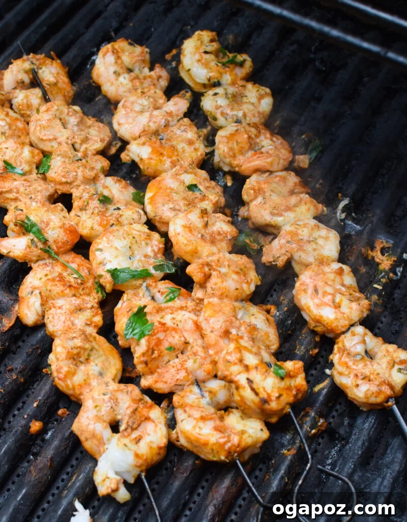 Zesty Mediterranean Grilled Shrimp Skewers 5 Mediterranean Grilled Shrimp Skewers cooking on a hot grill.