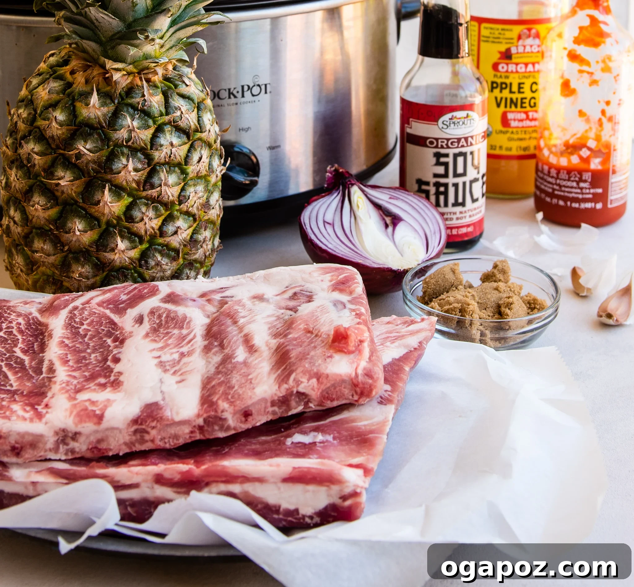 Luau-Inspired Slow Cooker Pork Ribs 5 A collection of fresh ingredients for Slow Cooker Hawaiian Pork Ribs including ginger, soy sauce, pineapple, and sriracha.