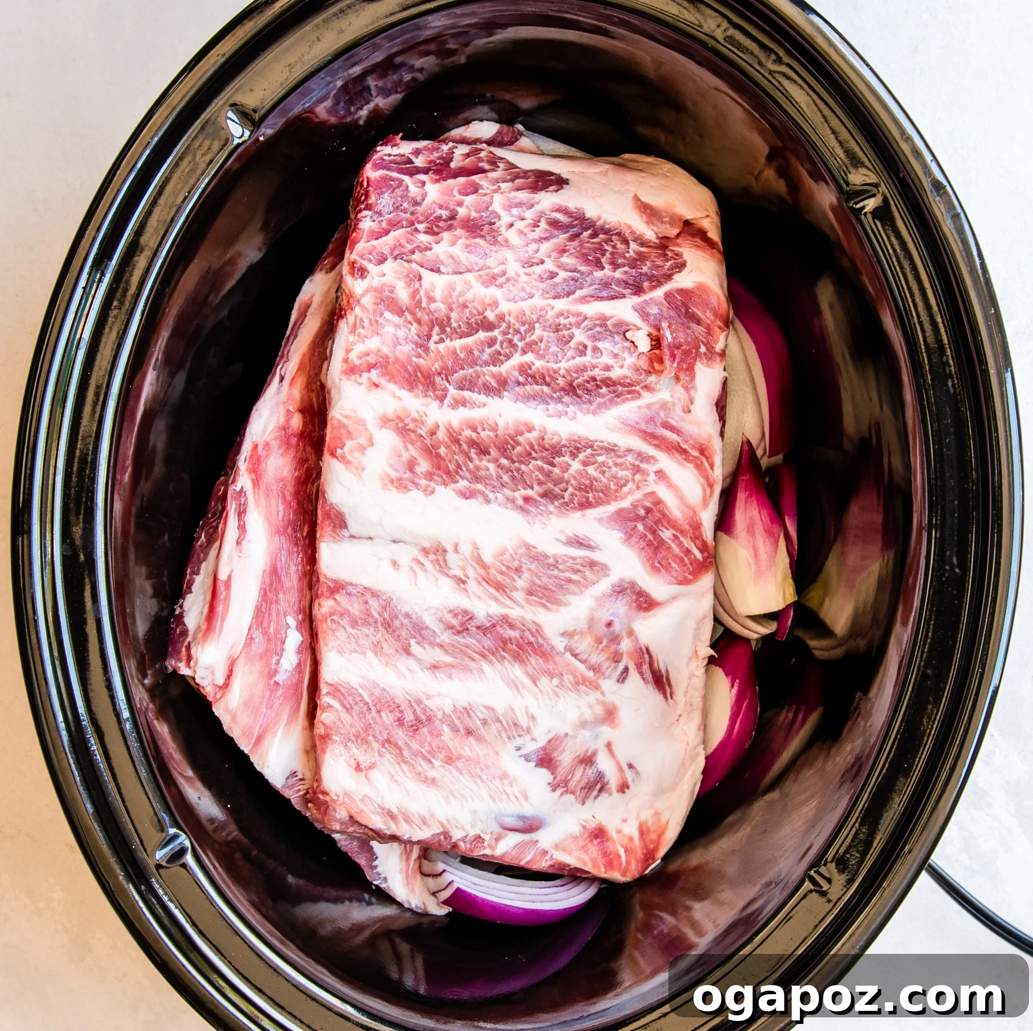 Luau-Inspired Slow Cooker Pork Ribs 8 Slow Cooker Hawaiian Pork Ribs nestled in the crockpot, submerged in the delicious sauce.