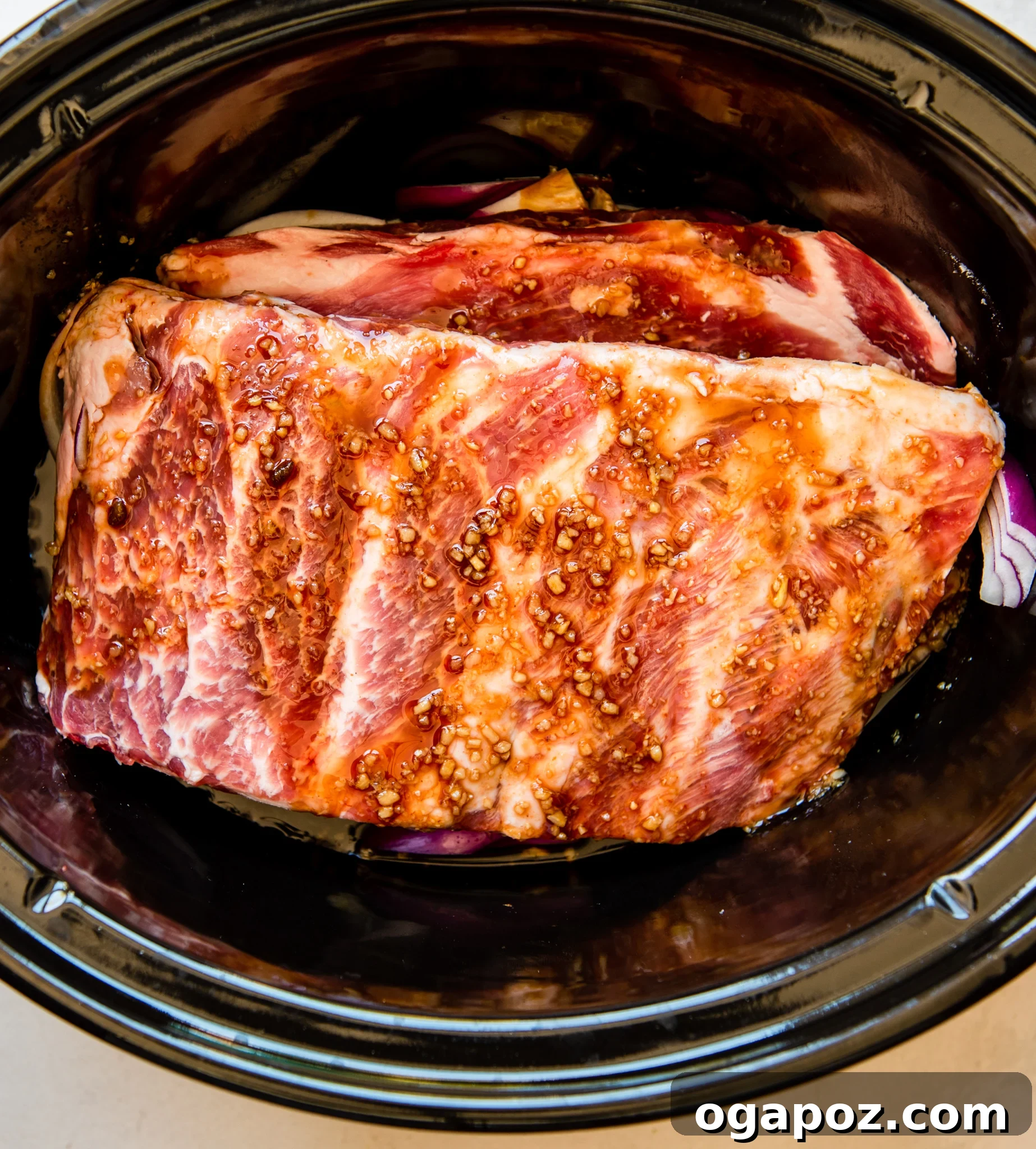 Luau-Inspired Slow Cooker Pork Ribs 9 Close-up of Slow Cooker Hawaiian Pork Ribs in the crockpot, showing their tender texture.