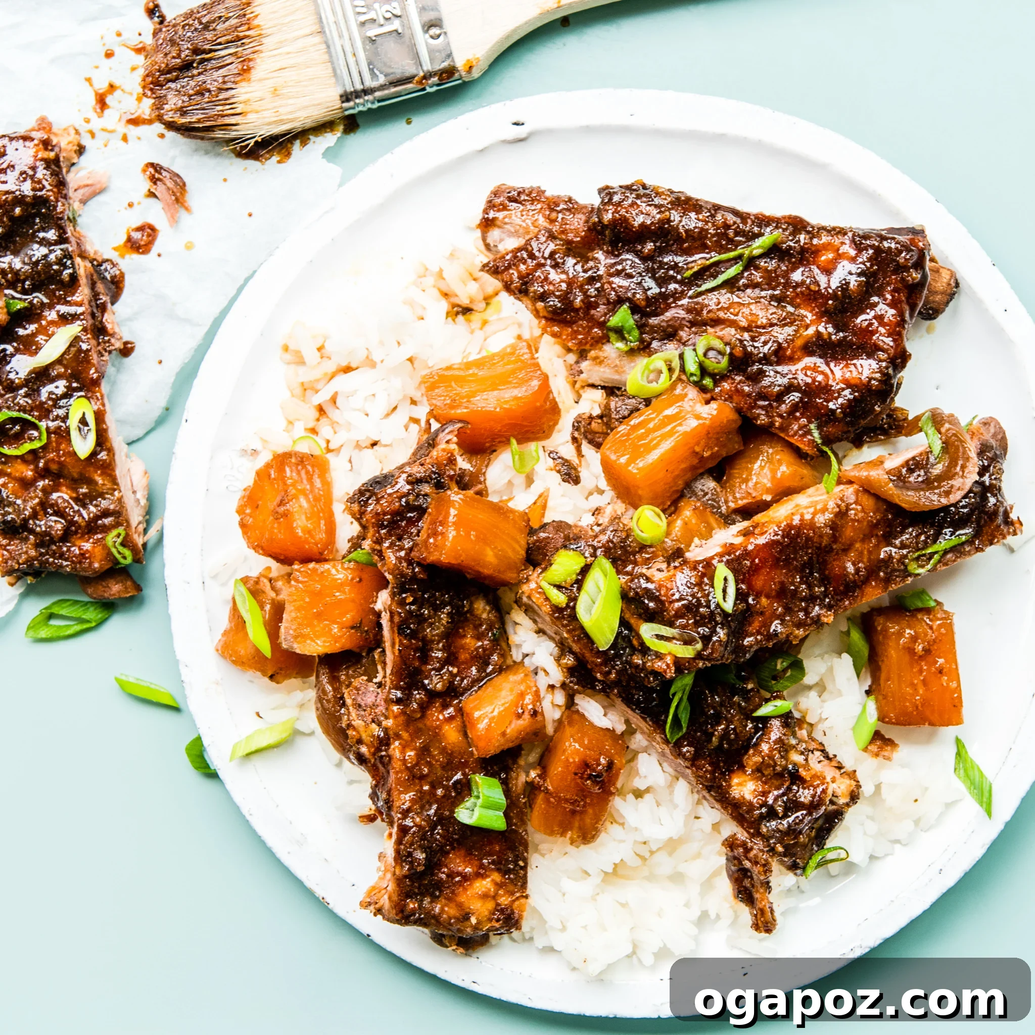 Luau-Inspired Slow Cooker Pork Ribs 10 A plate of Slow Cooker Hawaiian Pork Ribs, garnished and ready to eat, served with rice.