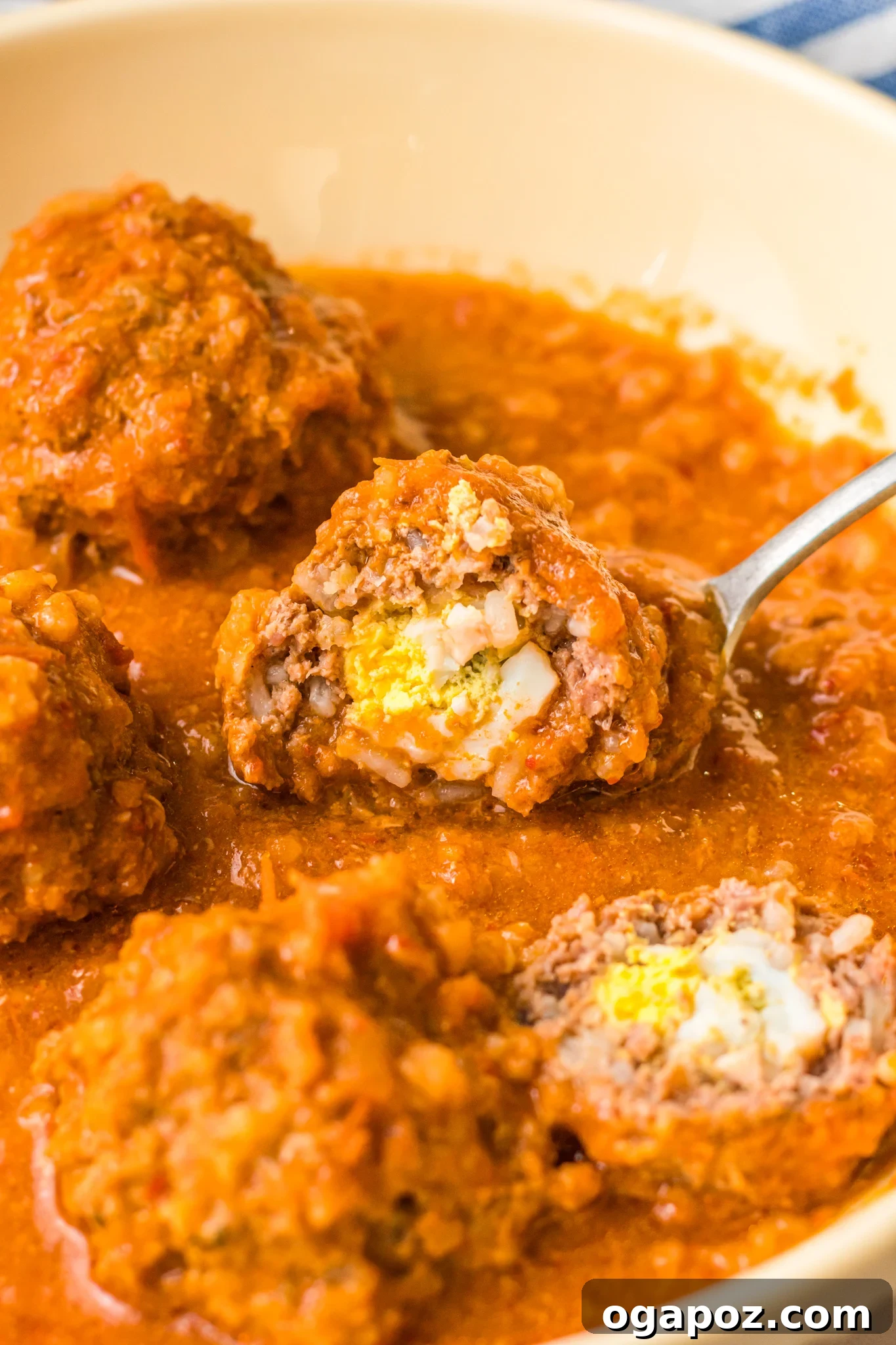 Smoky Chipotle Meatballs 12 A close-up of a cut Albondigas en Chipotle meatball, clearly showing the boiled egg embedded inside.
