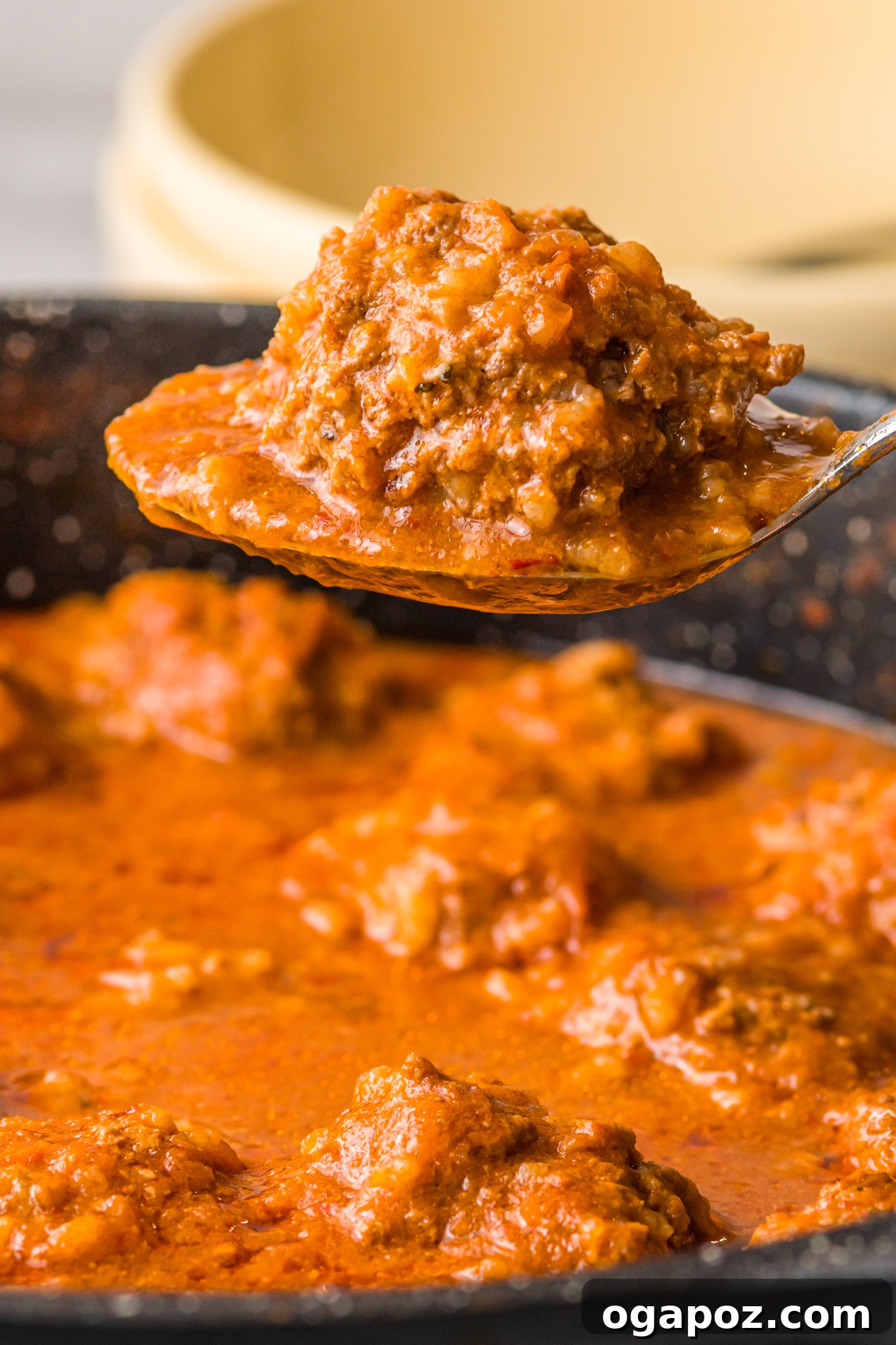 Smoky Chipotle Meatballs 13 A close-up of Albondigas en Chipotle being served from a pan with a large spoon, ready to be enjoyed.