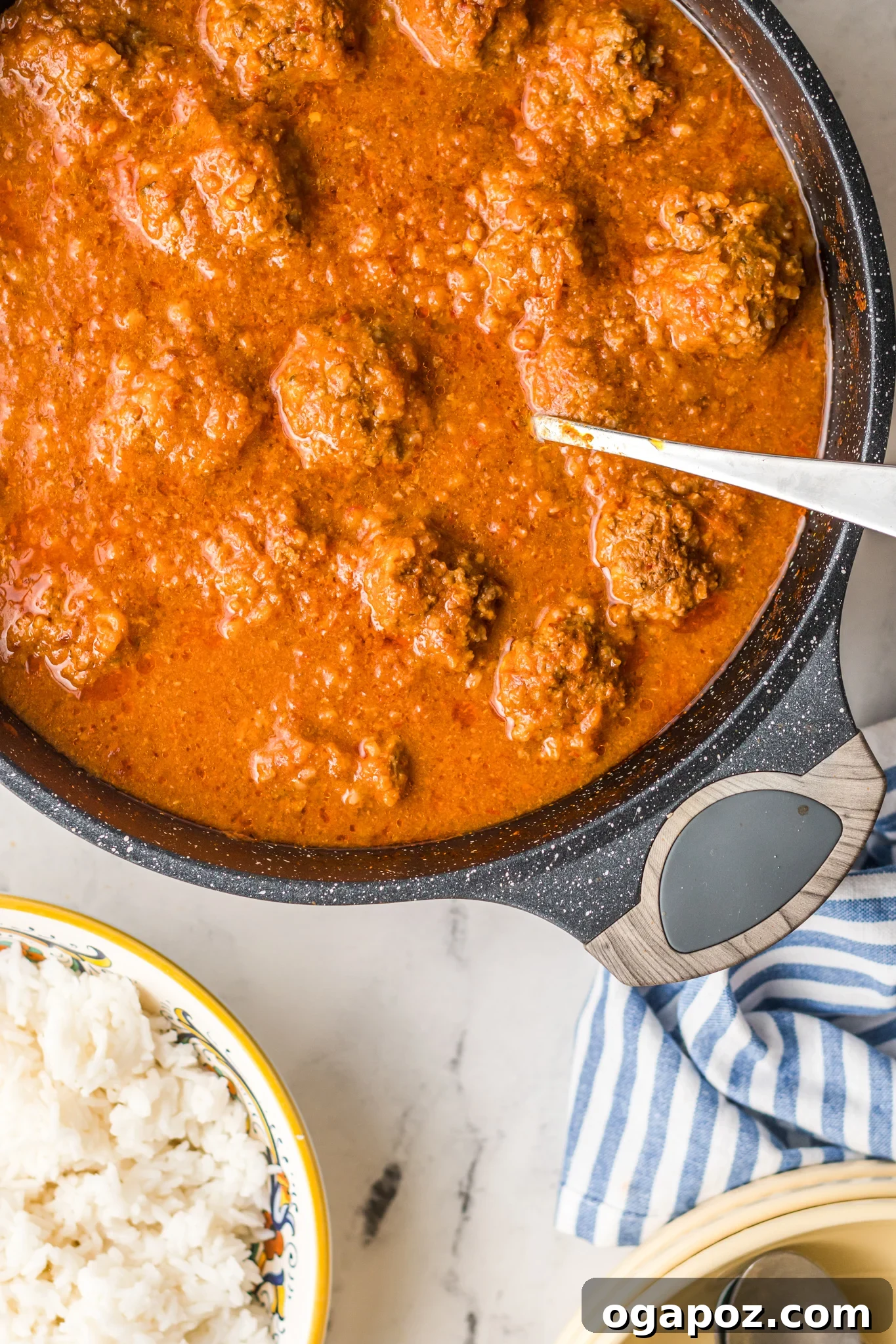 Smoky Chipotle Meatballs 4 Close-up shot of cooked Albondigas en Chipotle meatballs simmering in rich adobo sauce.