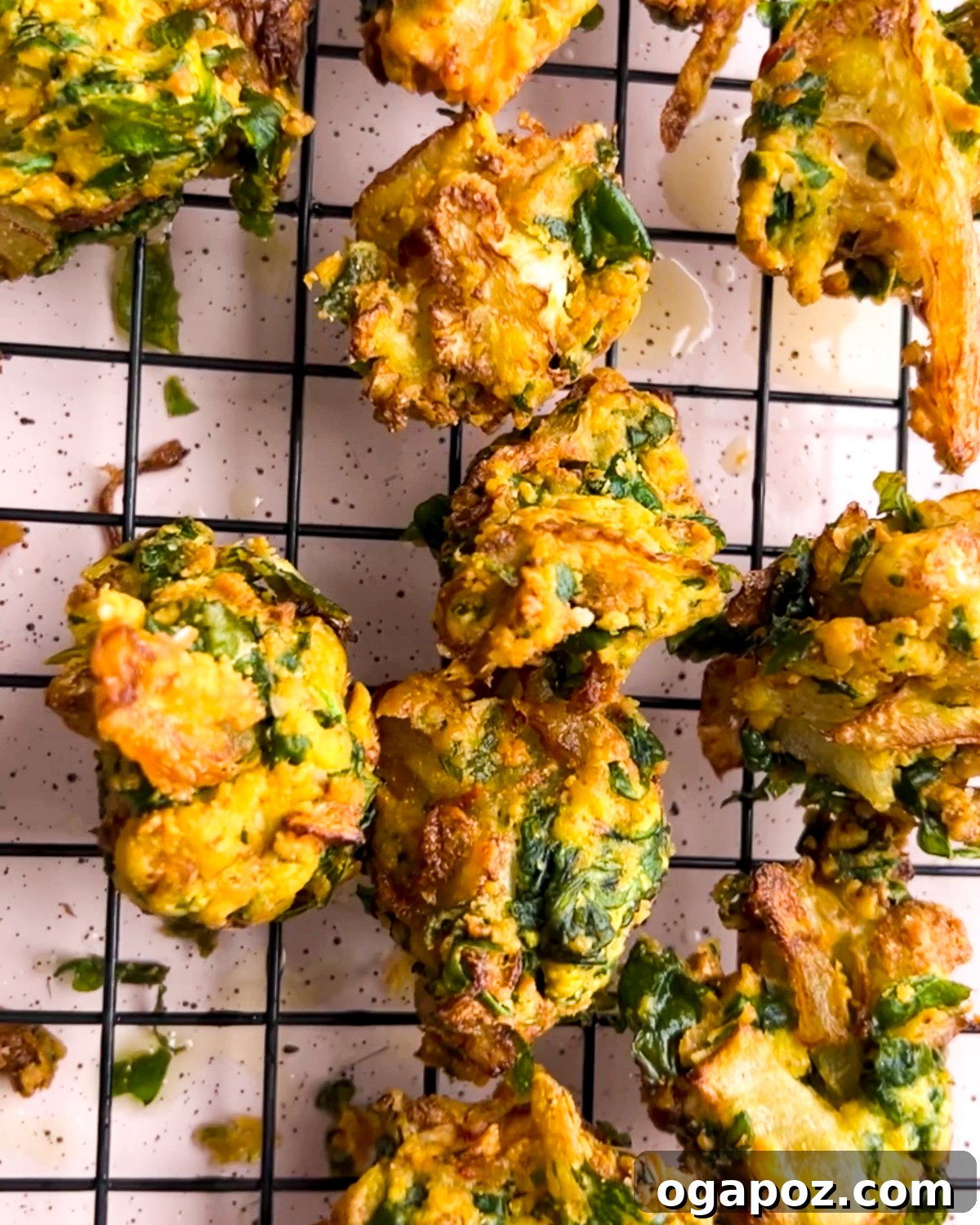 Indian Pakora Effortless Crispy Vegetable Fritters 2 Crispy golden pakora fritters piled on a wire rack, ready to be served, garnished with fresh cilantro.
