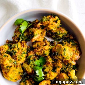 A bowl of freshly fried pakora, garnished with cilantro.