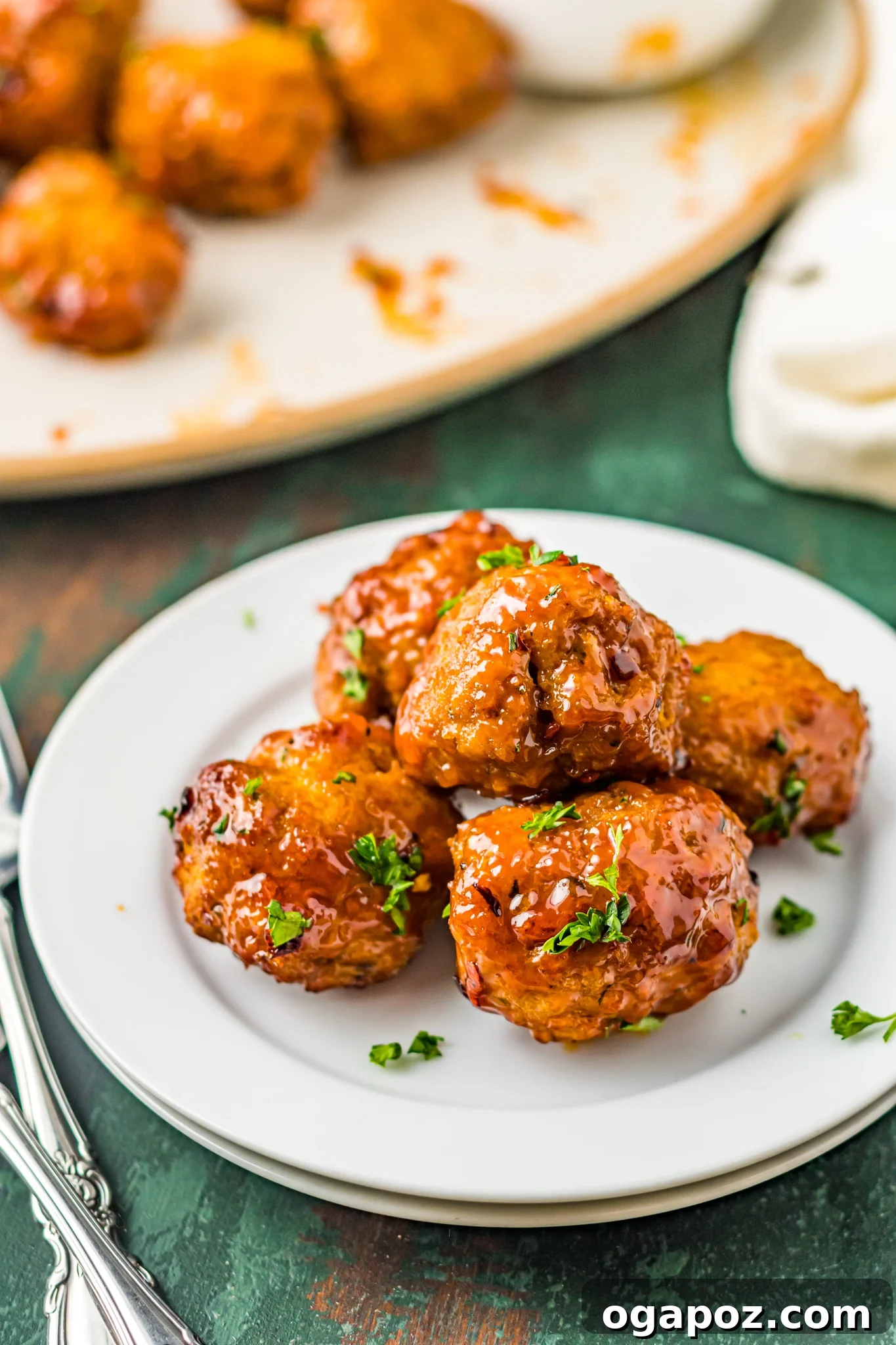 Crispy Air-Fried Meatballs 2 Plate of perfectly cooked Air Fryer Meatballs, glistening with spicy red sauce.