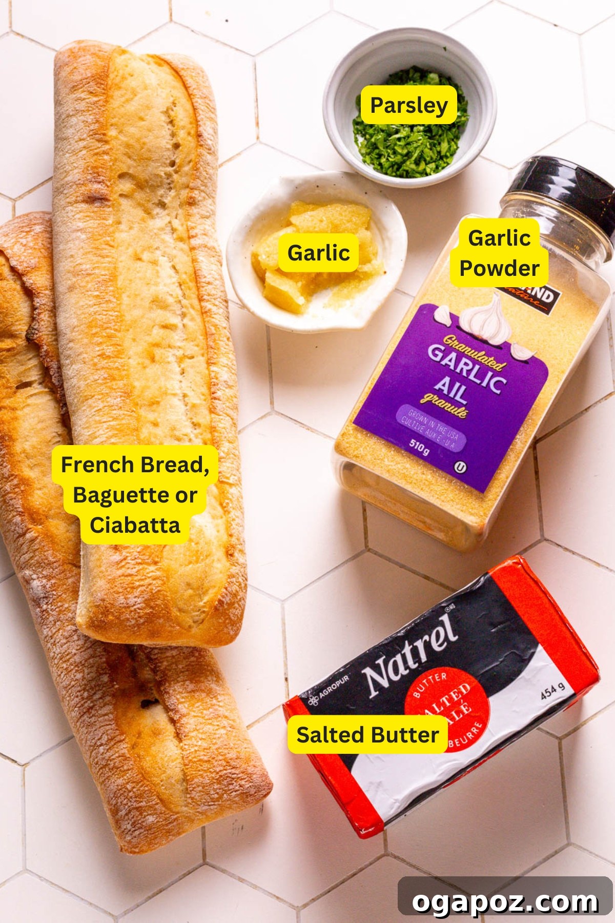Collection of fresh ingredients for homemade garlic bread including bread, butter, garlic, and parsley.