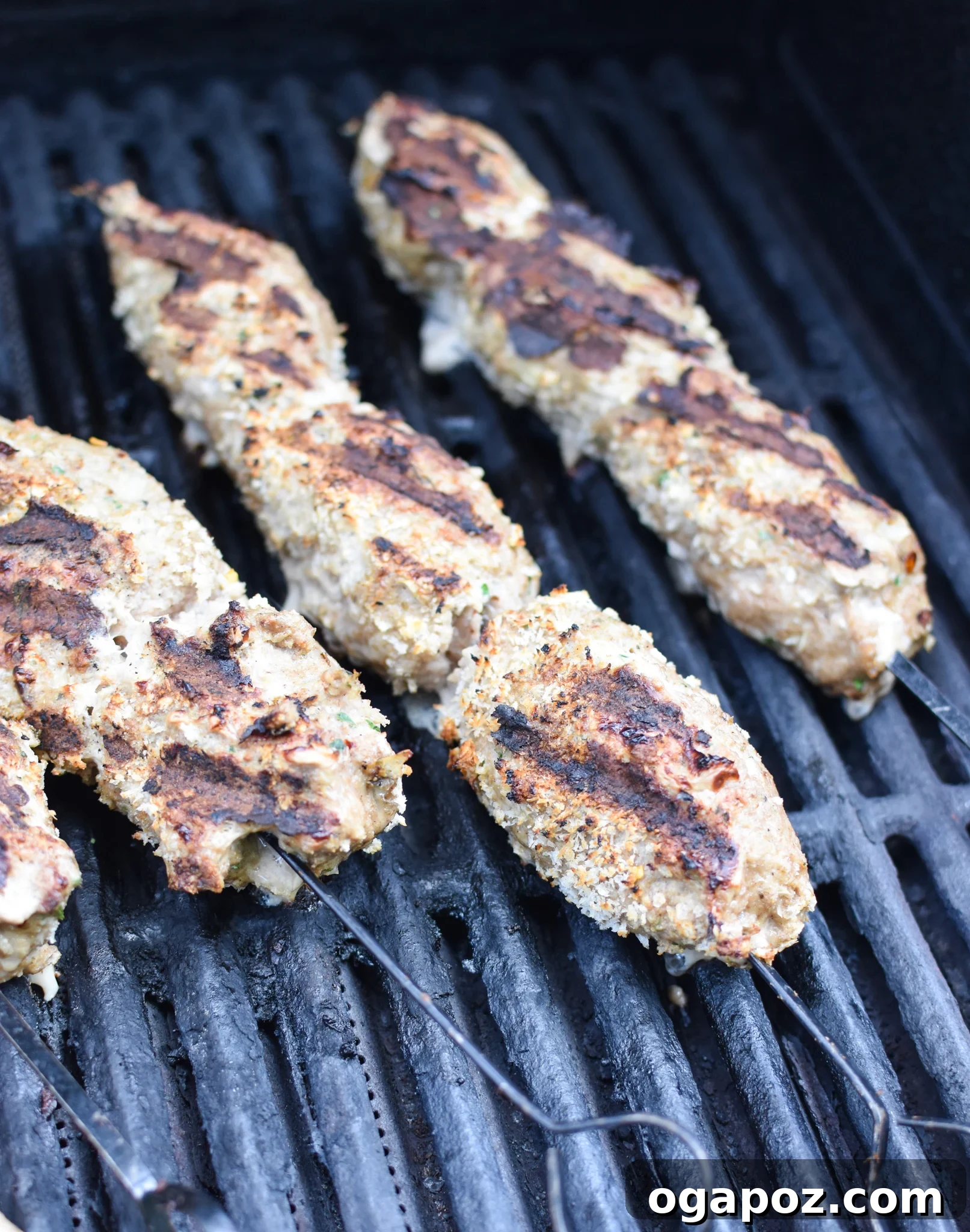 Spiced Turkey Kofta Skewers 6 Turkey Kofta Kebabs sizzling on a hot grill, showcasing the grilling process and the delicious char marks.
