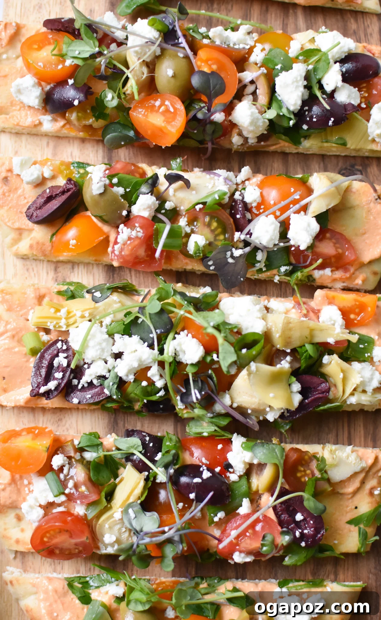 Sun-Kissed Mediterranean Naan Pizza 4 Mediterranean Naan Bread Pizza, perfectly sliced into wedges on a white plate, ready to serve.