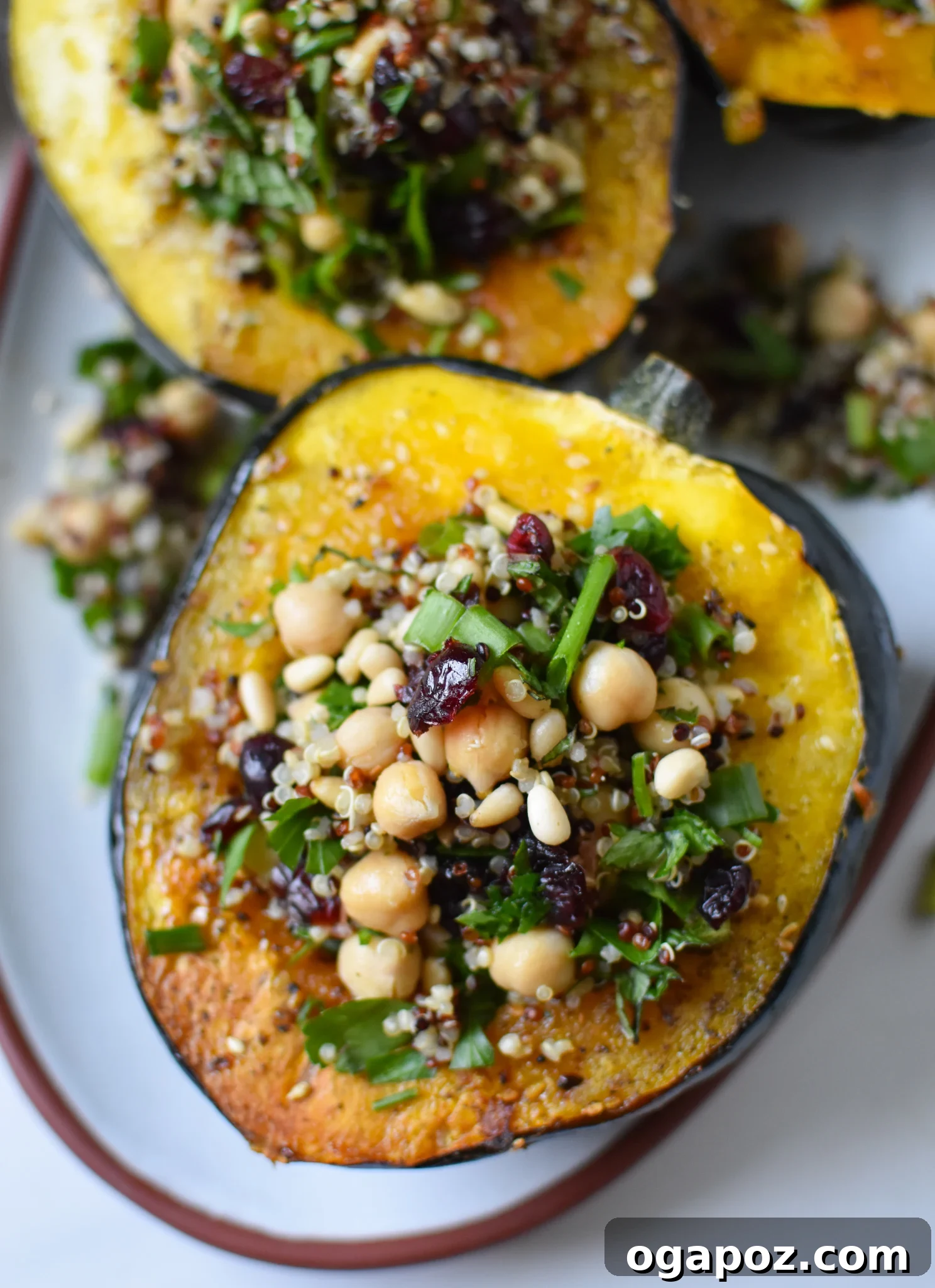 Sun-Kissed Mediterranean Stuffed Acorn Squash 2 Mediterranean Stuffed Acorn Squash with chickpeas and cranberries. A hearty, plant-based fall meal.