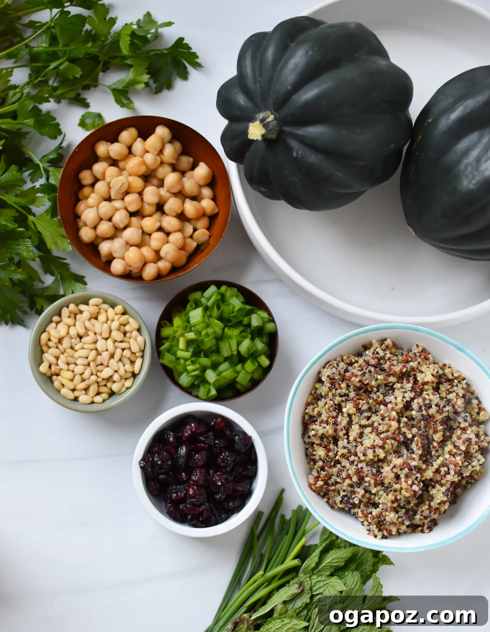 Sun-Kissed Mediterranean Stuffed Acorn Squash 5 Mediterranean Stuffed Acorn Squash ingredients laid out on a table.