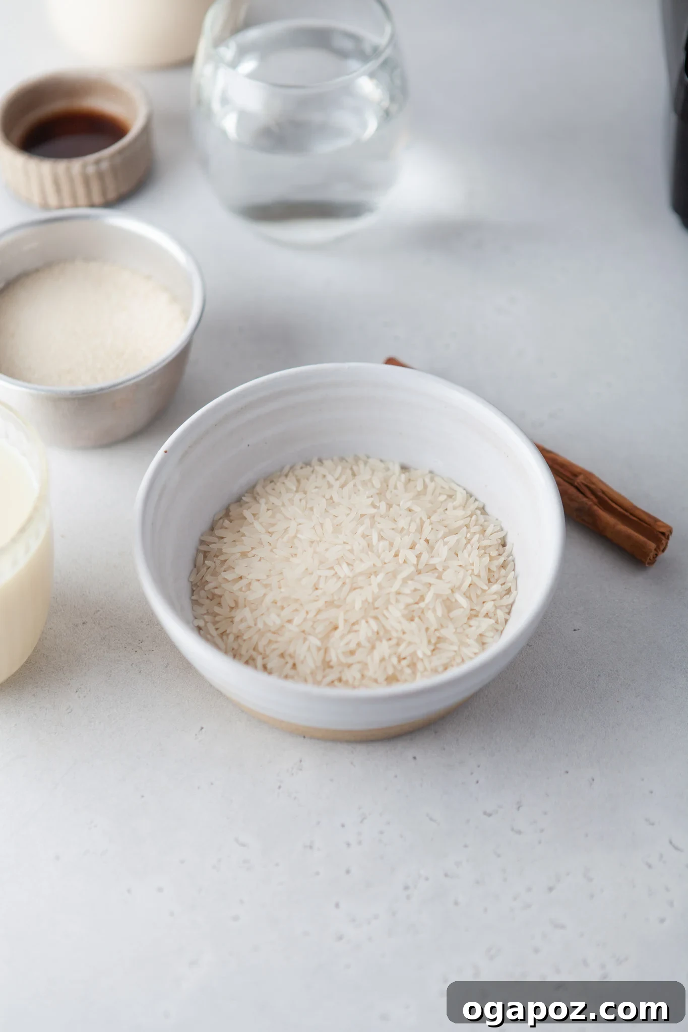 Sweet & Creamy Homemade Horchata 3 A collection of Horchata ingredients including white rice, cinnamon sticks, almonds, and milk cartons.