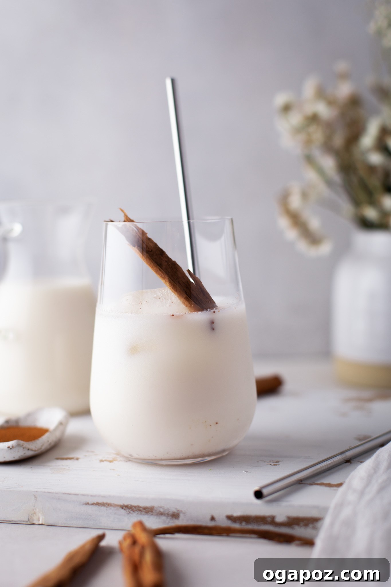 Sweet & Creamy Homemade Horchata 7 Horchata served in glasses with cinnamon sticks and a sprinkle of ground cinnamon.
