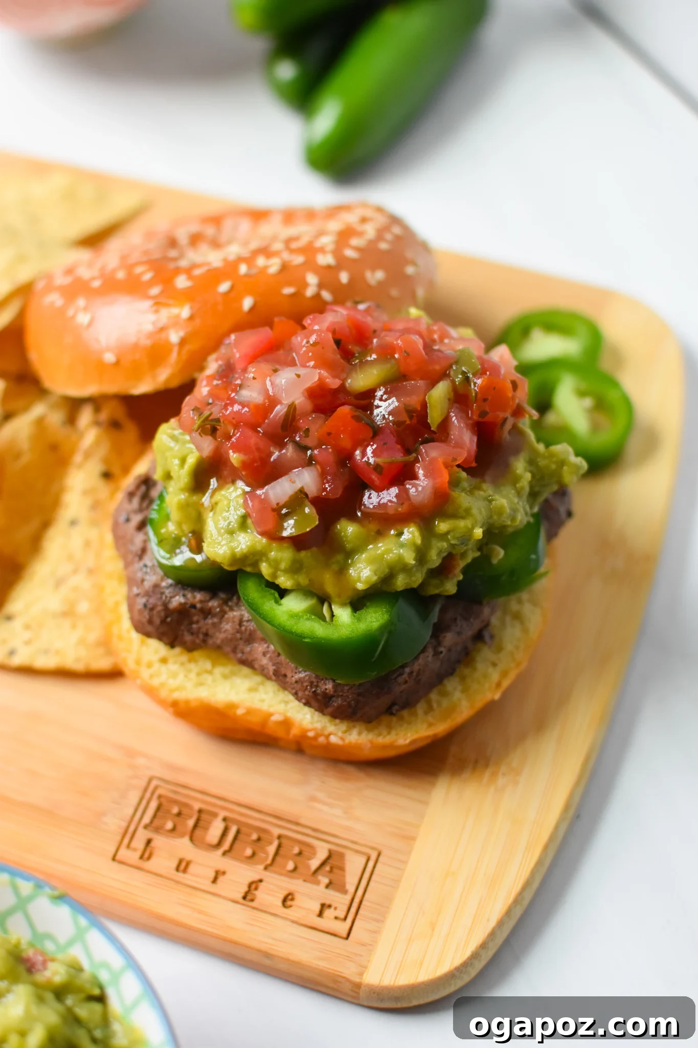 Tex Mex Fiesta Burger 4 Fully assembled Tex Mex Burger on a cutting board, ready to be served.