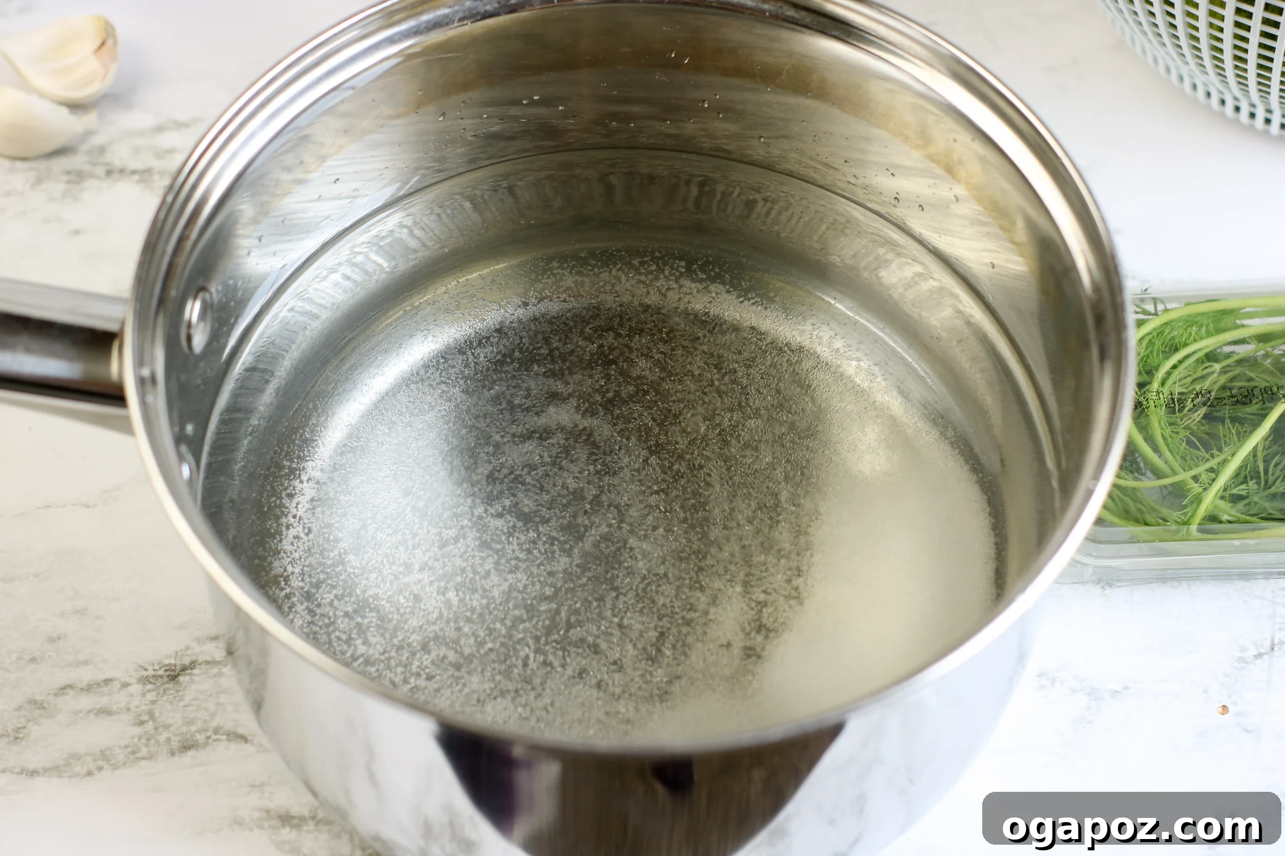 Easy No-Cook Dill Pickles 5 The pickling brine bubbling in a saucepan on the stovetop.