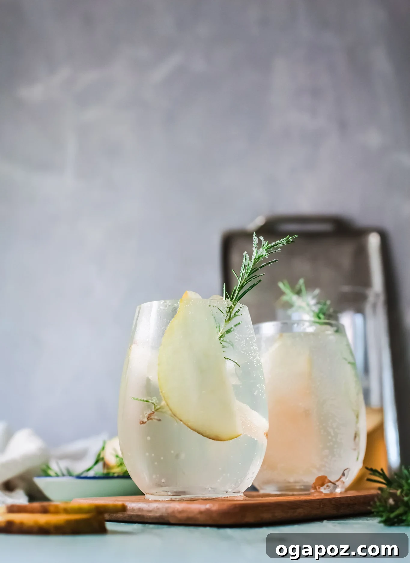 Refreshing White Sangria 3 Close-up of fresh rosemary sprigs and sliced pears, key garnishes for the White Sangria Recipe.