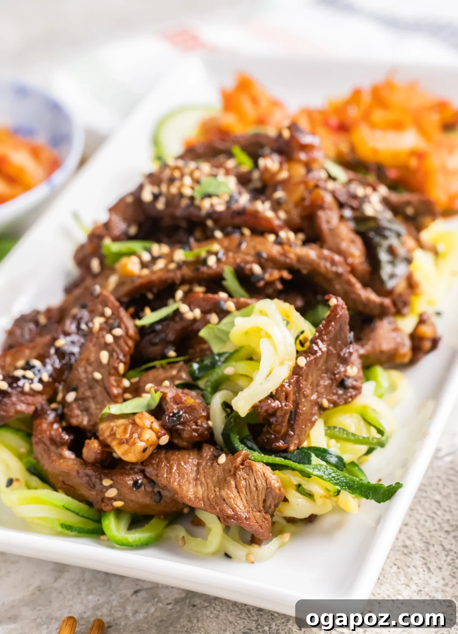 Savory Bulgogi Zucchini Ribbons 2 A vibrant plate of Beef Bulgogi with Zucchini Noodles, garnished with green onions and sesame seeds, ready to be enjoyed.
