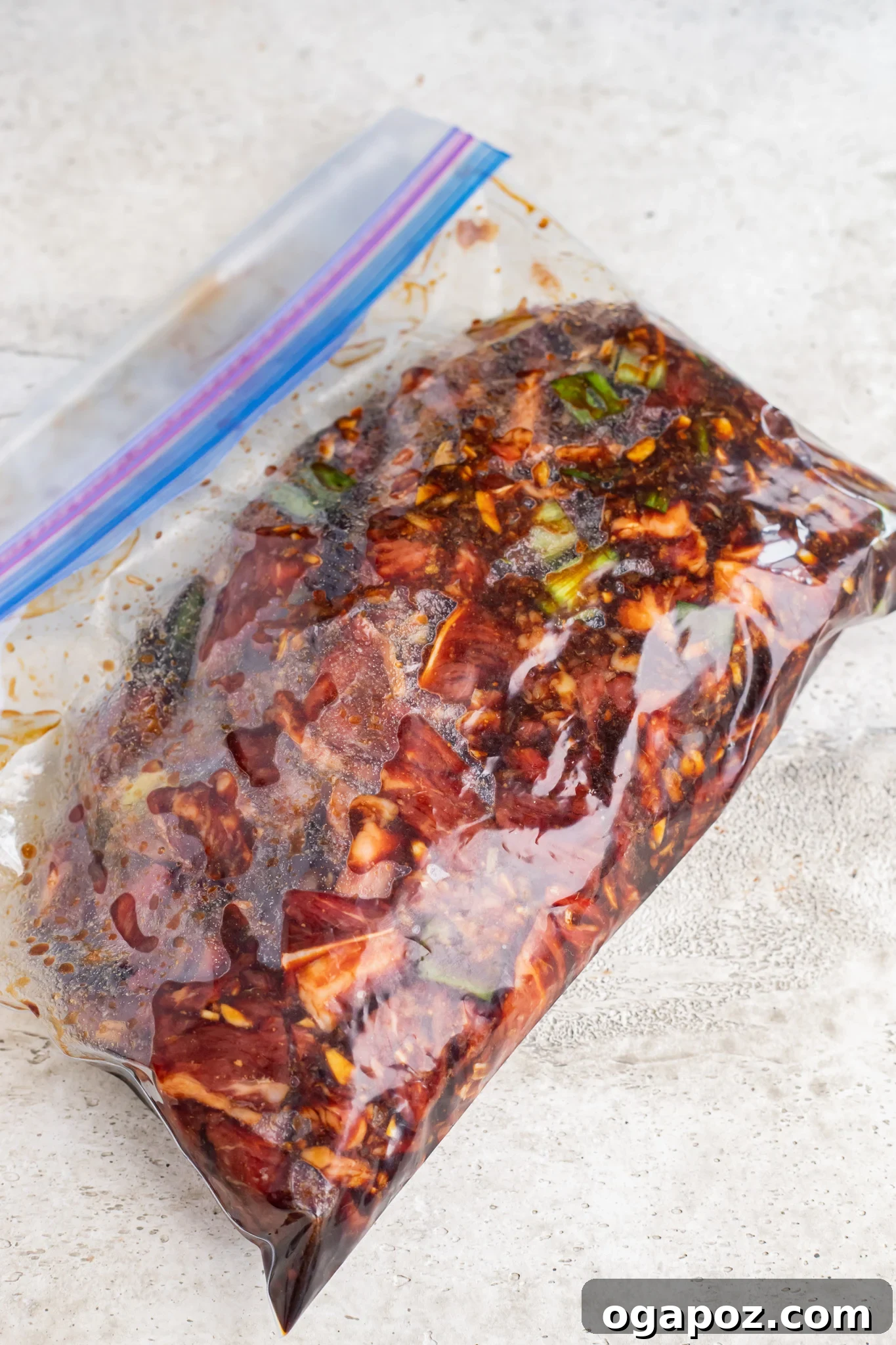 Savory Bulgogi Zucchini Ribbons 7 Thinly sliced beef marinating in a flavorful bulgogi sauce inside a ziplock bag, ready for grilling.