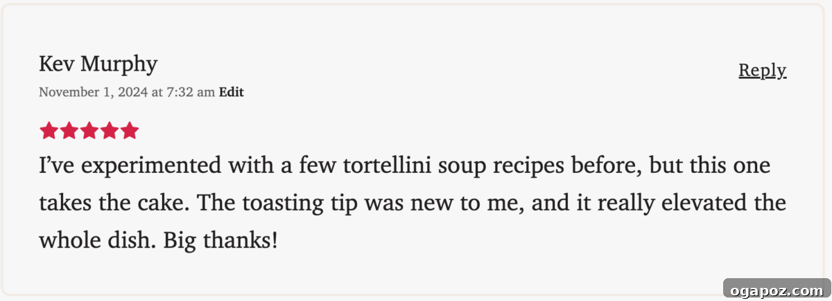 Creamy One-Pot Tortellini Soup 3 Overhead shot of creamy tortellini soup simmering in a pot.