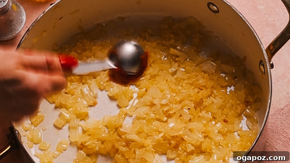 Creamy One-Pot Tortellini Soup 4 Step 1: Diced onions sautéing in olive oil in a large pot.