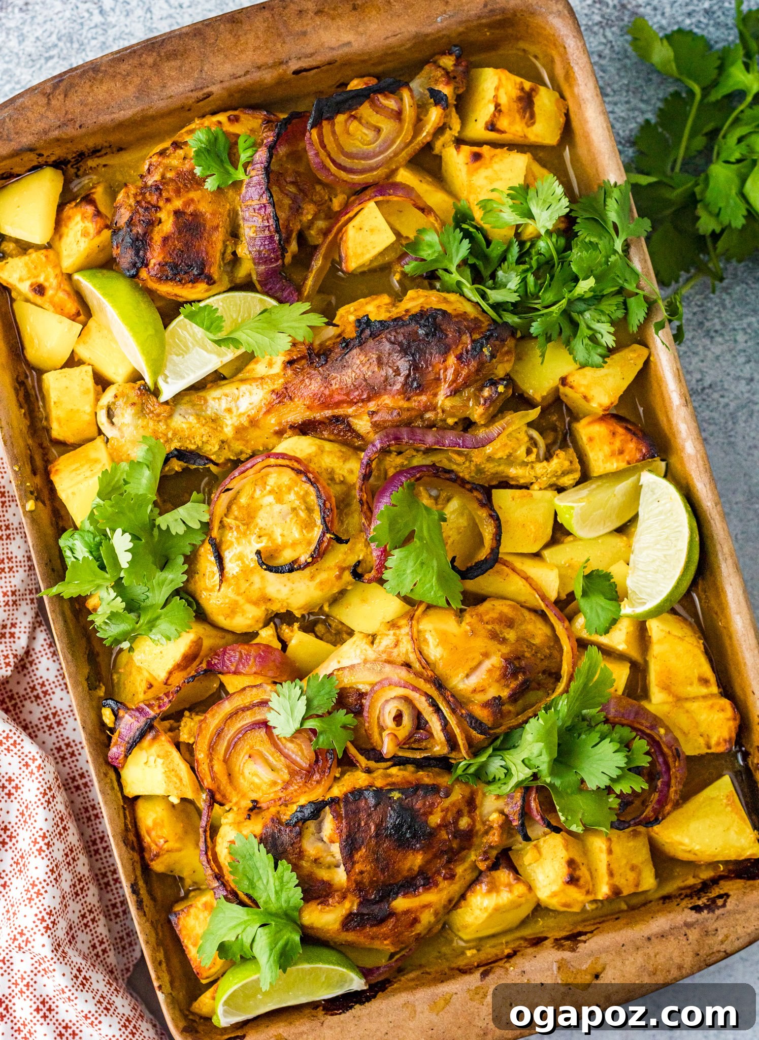 Crispy Air Fryer Tandoori Chicken Drumsticks 2 Crispy, golden-brown Air Fryer Tandoori Chicken Legs resting on a clean baking sheet, garnished with fresh cilantro, ready for serving.