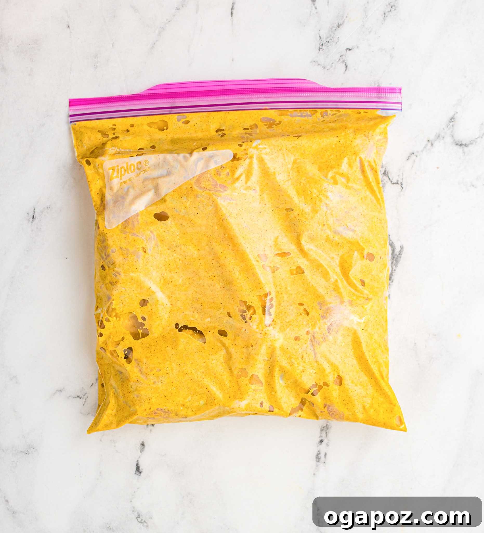 Crispy Air Fryer Tandoori Chicken Drumsticks 7 Chicken legs fully coated in the orange tandoori marinade, sealed inside a clear ziplock bag, marinating to absorb all the rich Indian flavors.