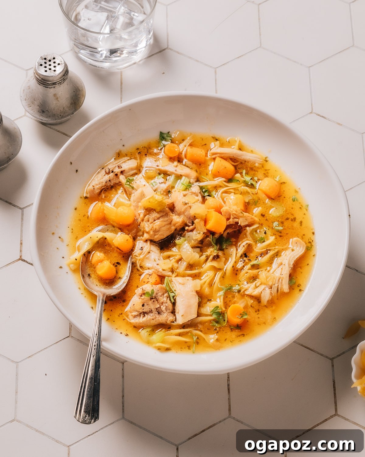 Effortless Instant Pot Chicken Soup for Busy Weeknights 7 A close-up of Instant Pot Chicken Soup in a rustic ceramic bowl, garnished and ready to eat.
