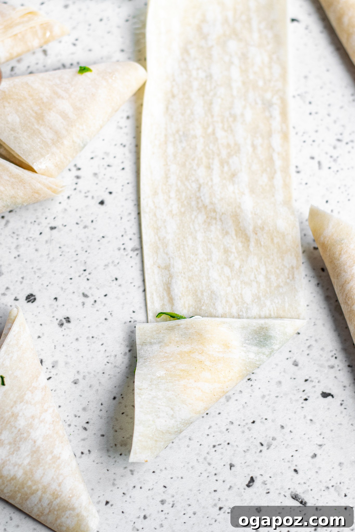Savory Spinach and Feta Phyllo Pastries 7 Partially folded Spanakopita Triangle showing the spinach and feta filling.