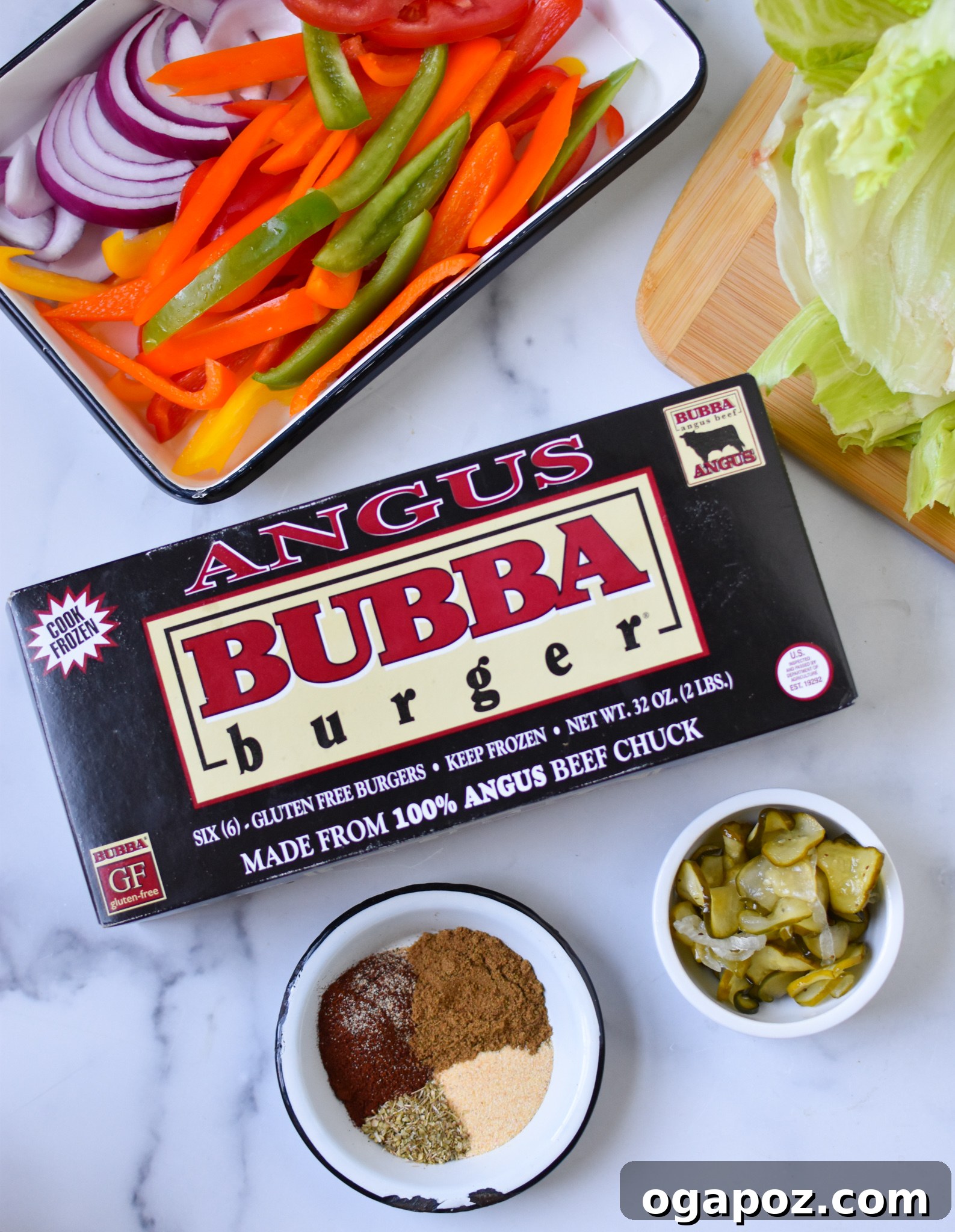 Fiesta Lettuce Burger 3 Ingredients for Fajita Lettuce Burger laid out, including BUBBA angus burgers, fresh lettuce, tomatoes, bell peppers, onions, and a bowl of taco seasoning.